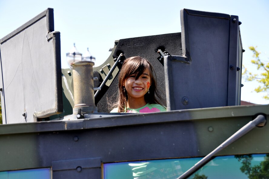 Makaela Lopez, 9, sticks her head out of the top of a 60th Security Forces Squadron Humvee Saturday in downtown Fairfield during the annual Tomato Festival. The annual Tomato celebration, hosted by the Fairfield Main Street Association, began 20 years ago and has grown into a large community event. (U.S. Air Force photo/Staff Sgt. Timothy Boyer)