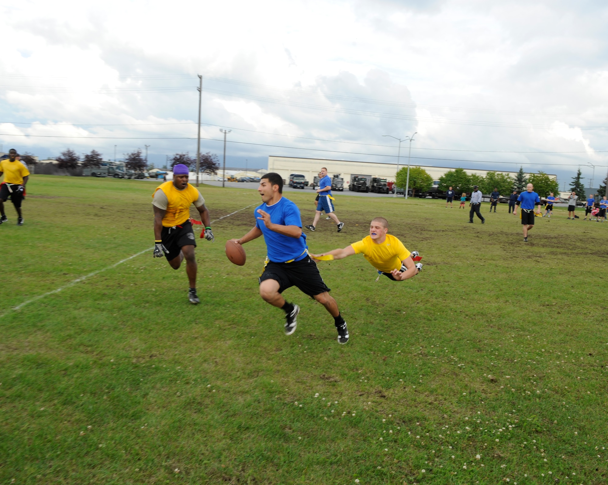 Airmen from the 673d Medical Group (blue shirts), lost to the 3rd Maintenance Squadron, 20-6 on Joint Base Elmendorf-RIchardson’s flag football field Monday. Autumn is approaching and the intramural flag football season is now on, with unit teams from around JBER battling it out at the Buckner Physical Fitness Center field and on the corner of Arctic Warrior Drive and Fairchild Avenue after duty hours. (U.S. Air Force photos/Steven White)