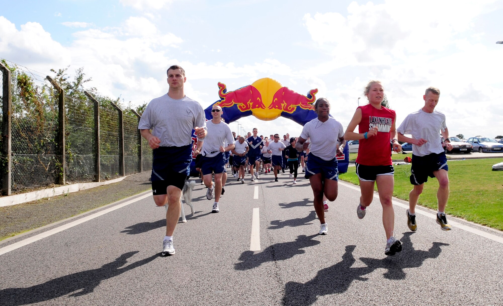 RAF MILDENHALL, England -- Members of the 100th Air Refueling Wing run a 5K wing fun run Aug. 25, 2011, at the running area near the Hardstand Fitness Center. The wing fun run is a monthly event to promote health, fitness and camaraderie amongst base members. (U.S. Air Force photo/Senior Airman Ethan Morgan)
