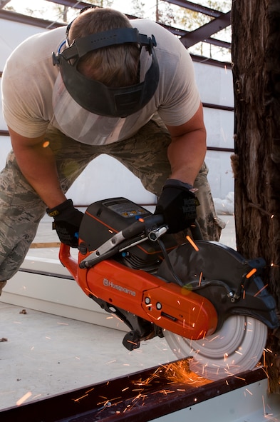 U.S. Air Force Senior Airman Ben Hamlett, 823rd RED HORSE Squadron from Hurlburt Field, Fla., uses a concrete saw during a warehouse build on Moody Air Force Base, Ga., Aug. 25, 2011. Hamlett and fellow RED HORSE civil engineers from Hurlburt Field use projects like the warehouse build to train for future rapid deployments. (U.S. Air Force photo by Staff Sgt. Joshua J. Garcia/Released)