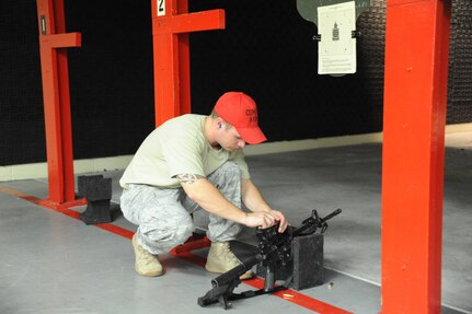 Airman 1st Class Johnathan Kuenzli, 902nd Security Forces Squadron, adjusts the sights on an M-4 carbine during small arms training at the Randolph Air Force Base firing range Aug. 23. (U.S. Air Force photo/Rich McFadden) (released)