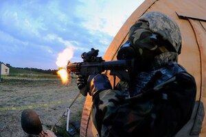 2nd Lt. Joseph Lindquist, 633rd Security Forces Squadron, fires an M-4 assault rifle at hostile forces during Exercise Eagle Flag at Joint Base McGuire-Dix-Lakehurst, N.J., Aug. 17. More than 250 Airmen and Soldiers from Joint Base Langley-Eustis recently returned from the week-long training exercise, which is designed to measure units’ ability to deploy and operate in austere environments. Fort Eustis deployed Soldiers from the 688th Rapid Port Opening Element to deliver cargo from the airfield, while Langley Air Force Base deployed Airmen from the 633rd Mission Support Group to establish and operate an expeditionary base. (U.S. Air Force photo by Tech. Sgt. Joanna Hensley/RELEASED)