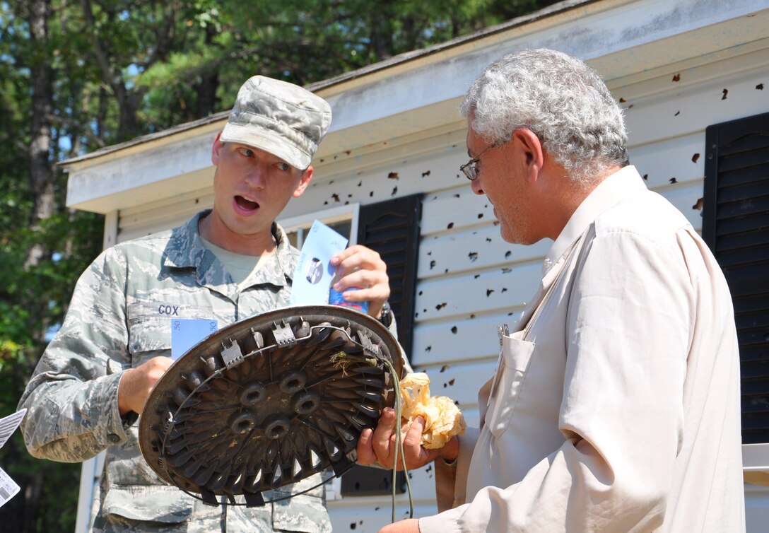 Senior Airman Mark Cox, 633rd Civil Engineer Squadron, haggles during a sale with a character actor portraying a Nessorian resident at Exercise Eagle Flag at Joint Base McGuire-Dix-Lakehurst, N.J., Aug. 17. More than 250 Airmen and Soldiers from Joint Base Langley-Eustis recently returned from the week-long training exercise, which is designed to measure units’ ability to deploy and operate in austere environments. Fort Eustis deployed Soldiers from the 688th Rapid Port Opening Element to deliver cargo from the airfield, while Langley Air Force Base deployed Airmen from the 633rd Mission Support Group to establish and operate an expeditionary base. (U.S. Air Force photo by Senior Airman Jason J. Brown/RELEASED)