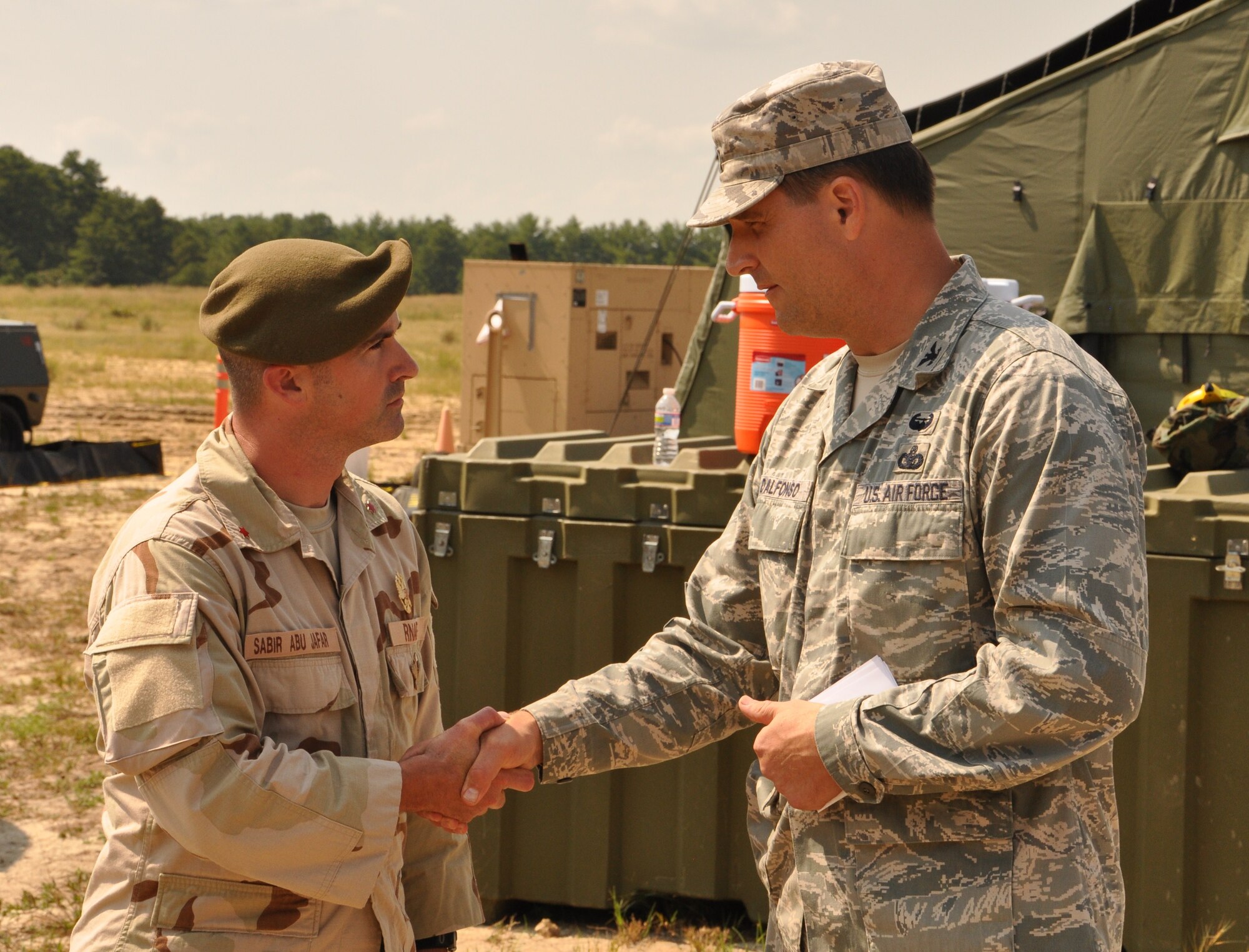 Col. Kenneth D’Alfonso, 633rd Mission Support Group commander (right), meets with a character actor portraying Royal Nessorian Air Force commander Col. Sabir Abu Jafar during Exercise Eagle Flag at Joint Base McGuire-Dix-Lakehurst, N.J., Aug. 17. More than 250 Airmen and Soldiers from Joint Base Langley-Eustis recently returned from the week-long training exercise, which was designed to measure units’ ability to deploy and operate in austere environments. Fort Eustis deployed Soldiers from the 688th Rapid Port Opening Element to deliver cargo from the airfield, while Langley Air Force Base deployed Airmen from the 633rd MSG to establish and operate an expeditionary base. (U.S. Air Force photo by Senior Airman Jason J. Brown/RELEASED)