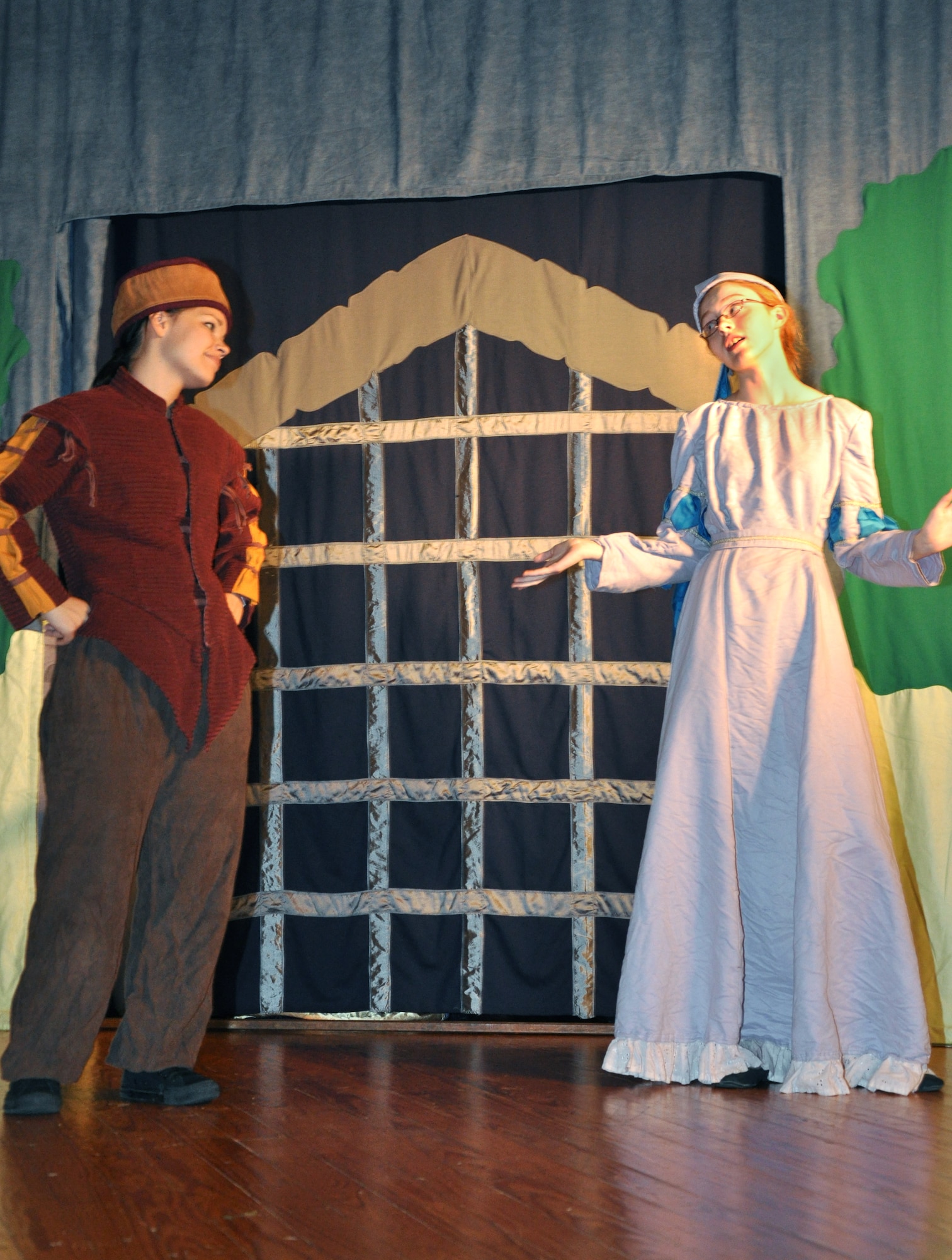 GOODFELLOW AIR FORCE BASE, Texas -- (From left:) Keeper of the Keep (Loretta Underwood) finds out why Damsel of the Second Order (Isabelle Ingalls) isn't part of the Damsels of the First Order during the Missoula Children's Theatre production of King Arthur's Quest Aug. 20 at the base theater here.  The Missoula Children's Theatre travels to 1,300 communities in the United States and in 17 countries each year fostering development life skills in more than a million youths.  (U.S. Air Force photo/Connie Hempel)