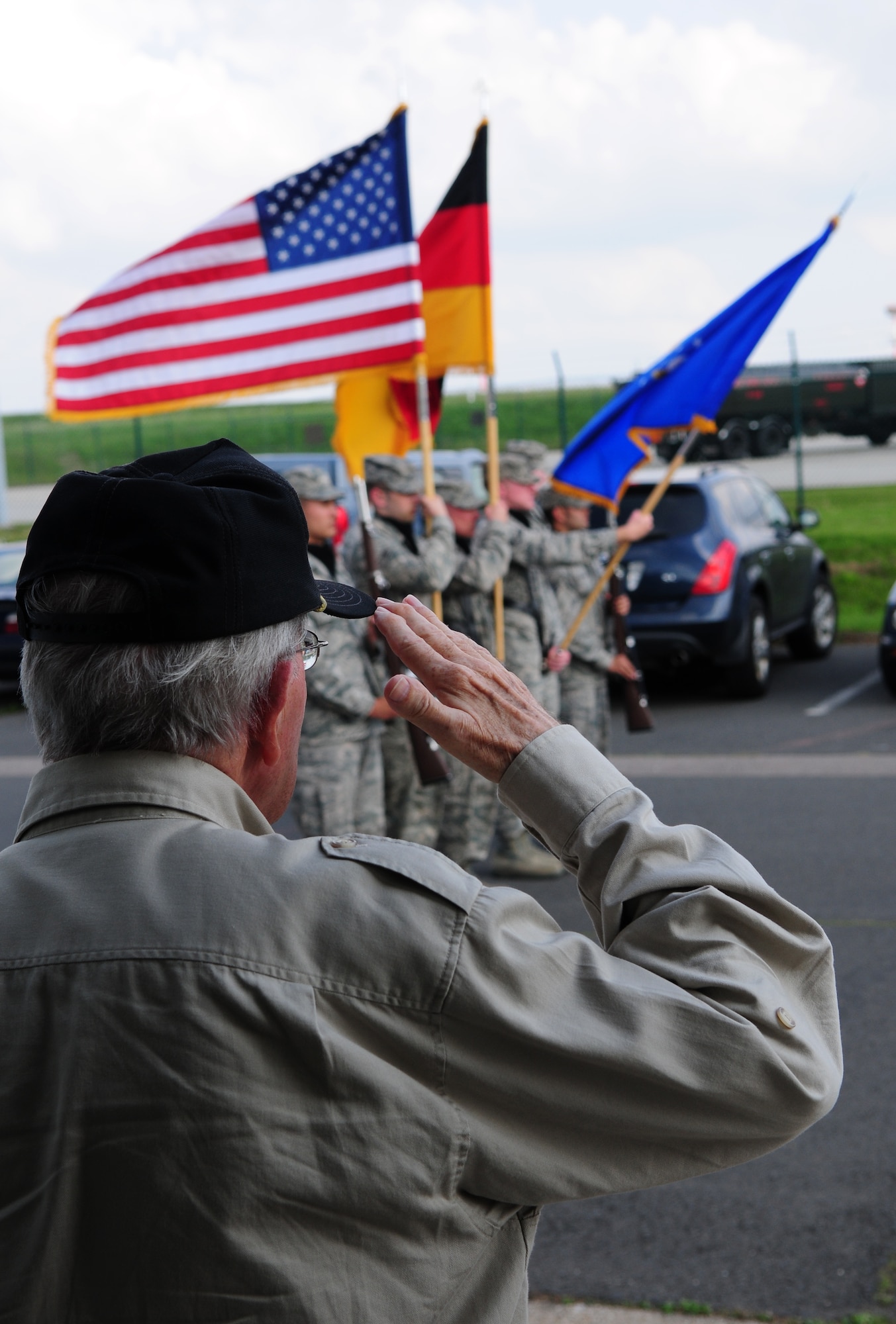 SPANGDAHLEM AIR BASE, Germany – Maurice Sperandieu, a Belgian World War II veteran, salutes the U.S. and German flags presented by the 52nd Fighter Wing Honor Guard while both countries’ national anthems are played at the end of the work day here Aug. 23. Sperandieu came to Spangdahlem with members of a Belgian WWII honor guard team that partners with the 52nd FW Honor Guard for joint events throughout Europe. Sperandieu encouraged today’s Airmen to remember the sacrifices of those who were killed in battle and recognize the cost of freedom. (U.S. Air Force photo/Airman 1st Class Matthew B. Fredericks)