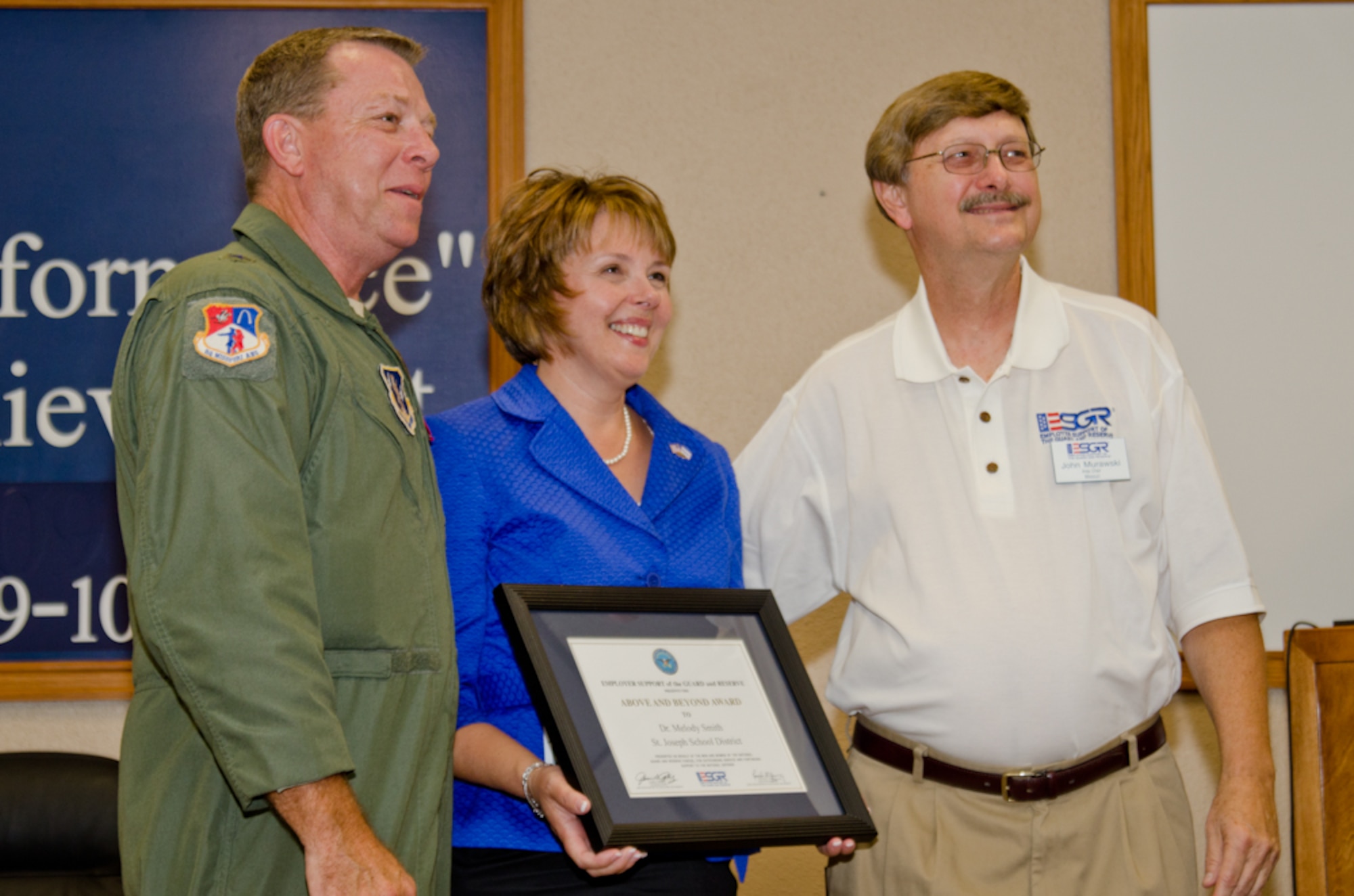 Brig. Gen. Stephen Cotter, Assistant Adjutant General for Air, Missouri Air National Guard, presents Dr. Melody Smith, Superintendent of the Saint Joseph School District, with the Department of Defense’s Employer Support of the Guard and Reserve (ESGR) award on August 22, 2011, in Saint Joseph, Mo. Dr. Smith received the “Above and Beyond Award” and the “Patriot Award” for her support of military families. (U.S. Air Force photo by Senior Airman Sheldon Thompson)