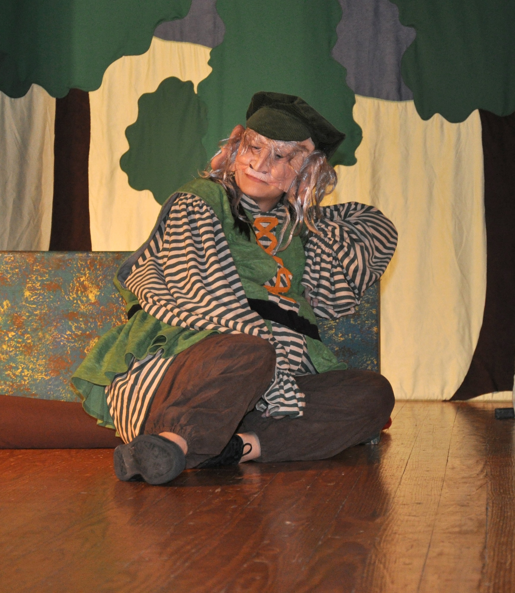 GOODFELLOW AIR FORCE BASE, Texas -- Recalcitrant Giant, played by Loretta Underwood, gets ready to take a nap during the Missoula Children's Theatre production of King Arthur's Quest Aug. 20 at the base theater here.  The Missoula Children's Theatre travels to 1,300 communities in the United States and in 17 countries each year fostering development life skills in more than a million youths.  (U.S. Air Force photo/Connie Hempel)