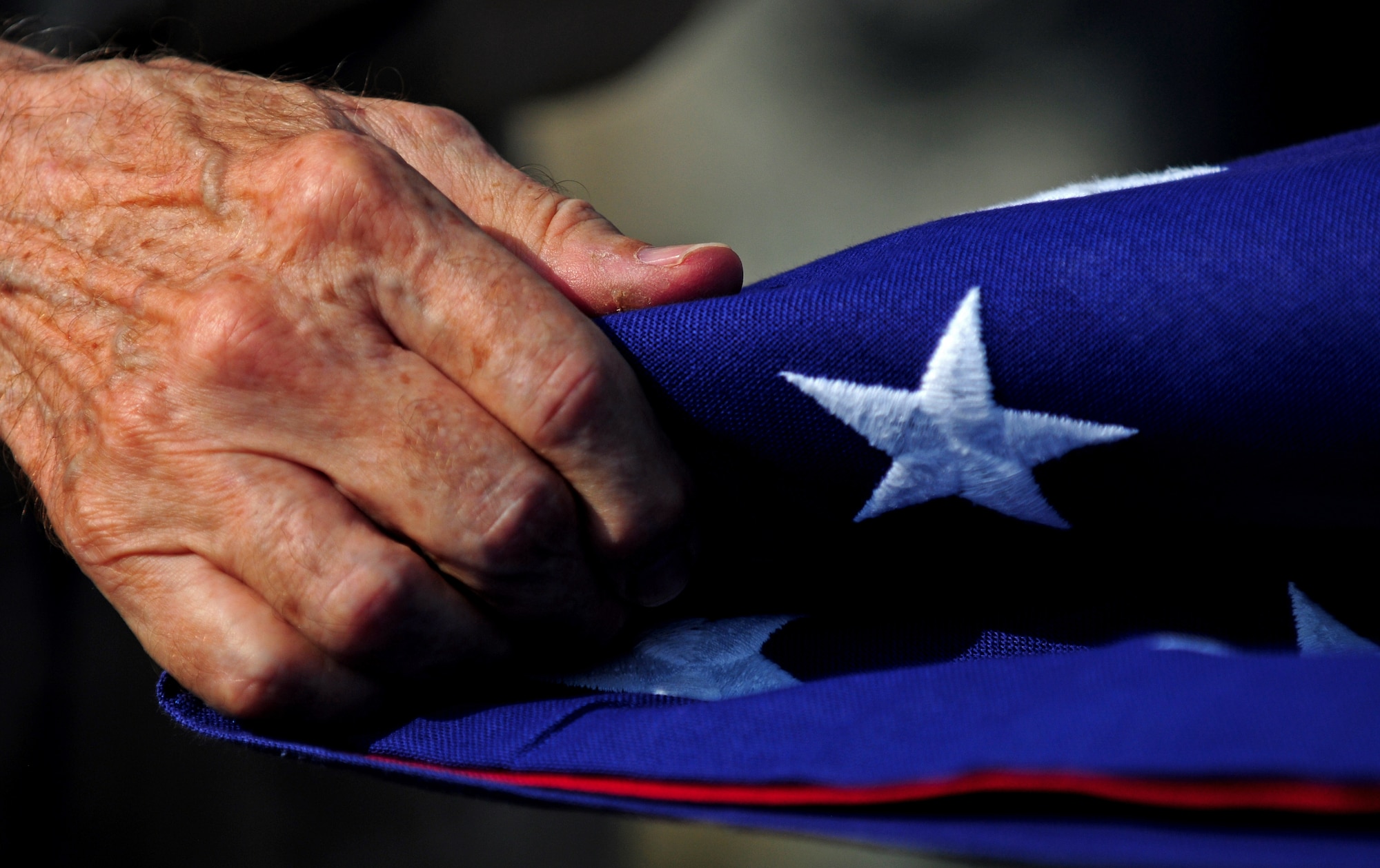SPANGDAHLEM AIR BASE, Germany – Maurice Sperandieu, a Belgian World War II veteran, participates in a flag folding ceremony here Aug. 23.  Sperandieu came to Spangdahlem with members of a Belgian WWII honor guard team that partners with the 52nd Fighter Wing Honor Guard for joint events throughout Europe. Sperandieu encouraged today’s Airmen to remember the sacrifices of those who were killed in battle and recognize the cost of freedom. (U.S. Air Force photo/Airman 1st Class Matthew B. Fredericks)