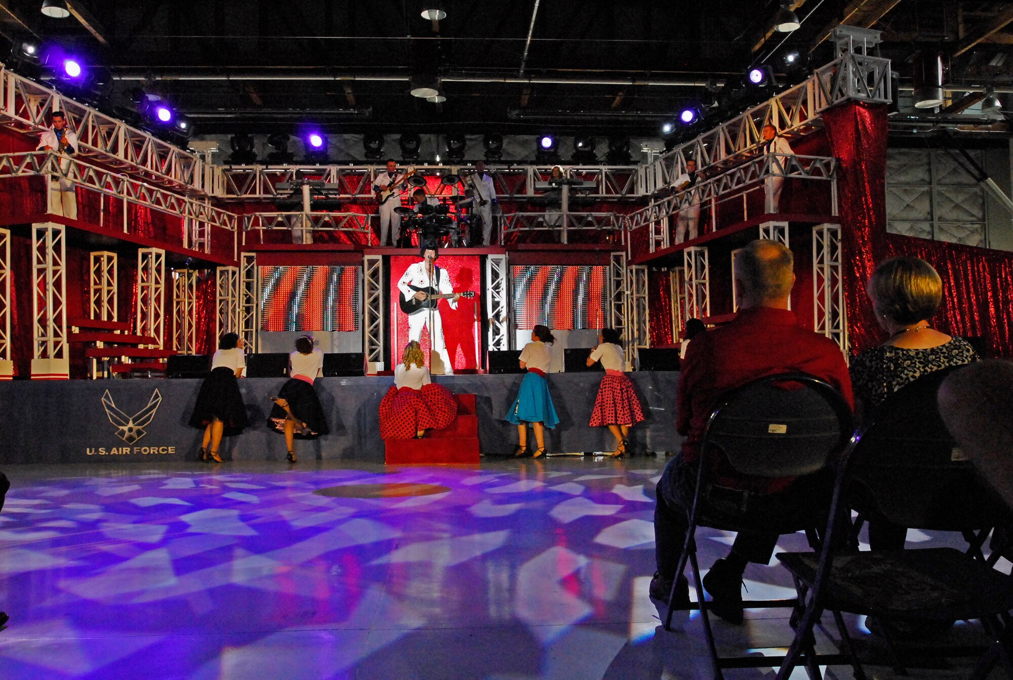 Audience members watch a performance by the Air Force’s premier entertainment group, Tops in Blue, in Hangar 140 on Peterson Air Force Base, Aug. 21. This year’s TiB tour theme is "Rhythm Nation." (U.S. Air Force photo/Senior Airman Jessica Hines)