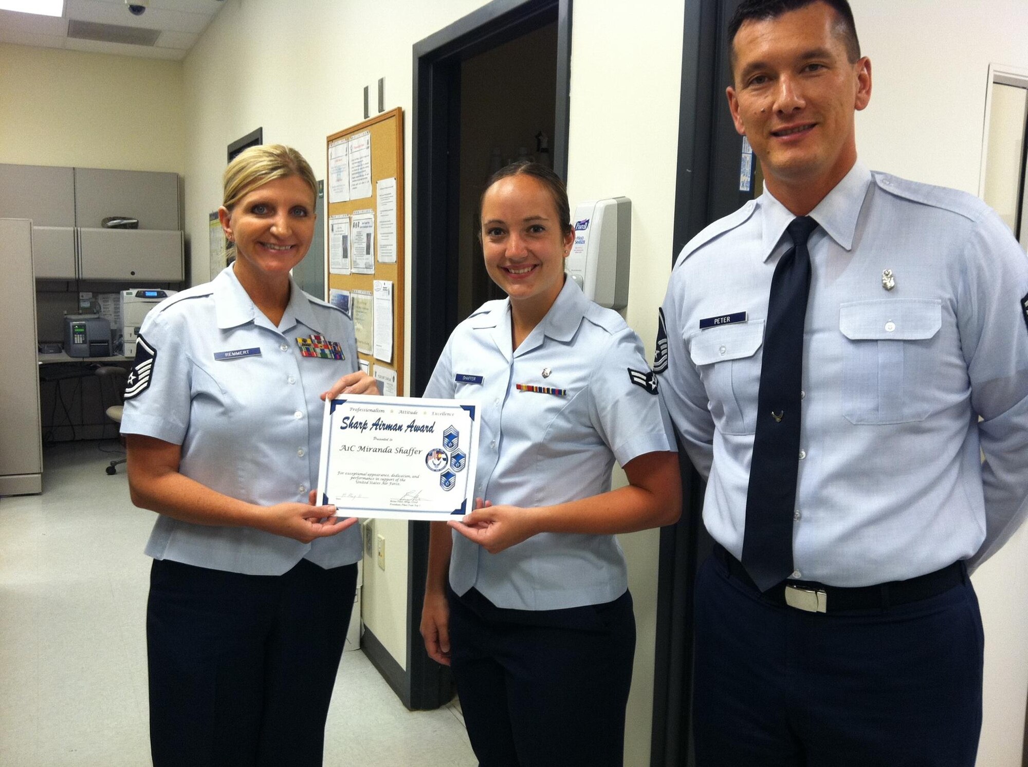 PETERSON AIR FORCE BASE, Colo. –The Pike's Peak Top 3 selected Airman 1st Class Miranda Shaffer (center), 21st Medical Support Squadron, for its Sharp Warrior award. Presenting the award are Master Sgt. Kelli Remmert (left), 21st Aerospace Medicine Squadron and Master Sgt. Brian Peter, Pike's Peak Top 3 President. According to the Top 3, Shaffer's noticeable performance in exceeding Dress and Personnel Appearance standards and following traditional customs and courtesies was evident to her superiors and peers while part of the Peterson High Frontier Honor Guard. She served as judge and inspector for local state-level high school drill competitions, and her and her teams impeccably executed 30 funerals, 26 color postings and 16 retirements. For information about the Sharp Warrior award, email Remmert at kelli.remmert@peterson.af.mil. (Courtesy photo)