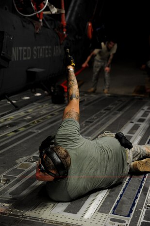 A U.S. Army Soldier from the 3rd Battalion, 160th Special Operations Aviation Regiment, Hunter Army Air Field, Ga., guides a MH-60 Blackhawk helicopter from a C-17 Globemaster III at Joint Base Charleston, S.C., Aug. 23.   (U.S. Air Force photo/ Staff Sgt. Nicole Mickle)  