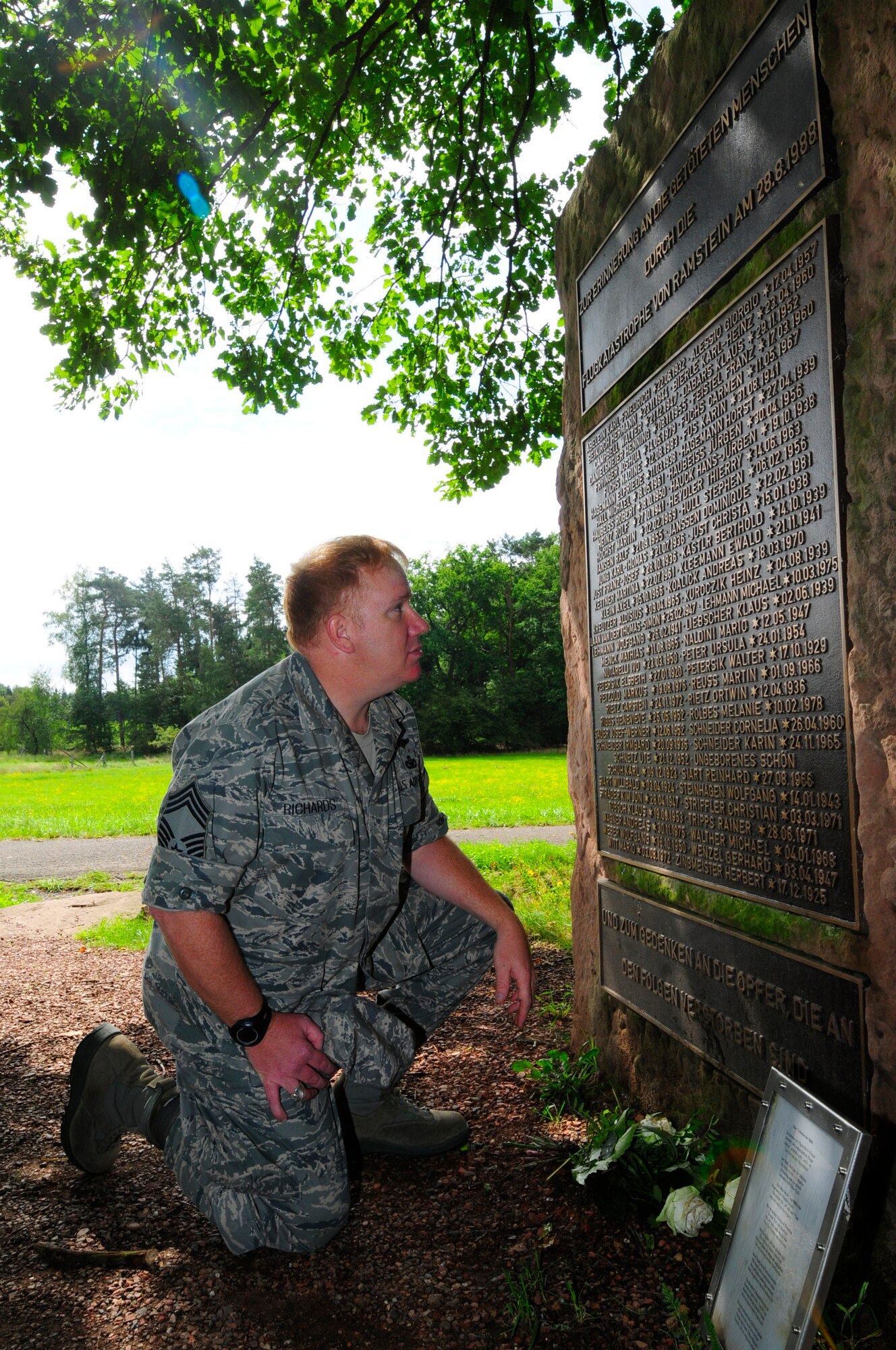 Chief Master Sgt. David Richards reads names from the Flugtaggedenkstatte, a
memorial built to commemorate the 70 people killed in the Flugtag Air Show
Disaster in 1988. Richards is a survivor of the tragedy, now stationed at
Ramstein Air Base 23 years later. (U.S. Air Force photo by Airman Kendra
Alba)  

