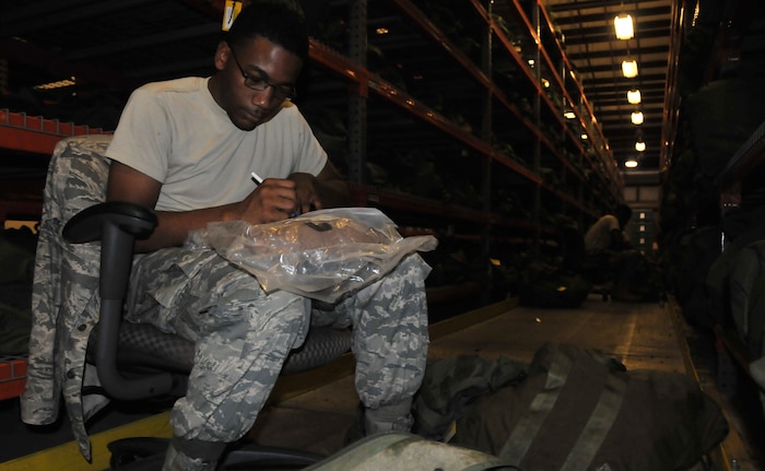 Airman 1st Class Ladarrin Tolbert  inspects the shelf life of a chemical warfare bag, Aug .23, 2011, at Joint Base Charleston-Air Base. The Individual Protective Equipment shop plays a vital role to the success of the upcoming Operational Readiness Inspection. Tolbert is an IPE apprentice and  part of the Material Management Flight from the 628th Logistics Readiness Squadron. (U.S. Air Force photo/Airman 1st Class Jared Trimarchi)