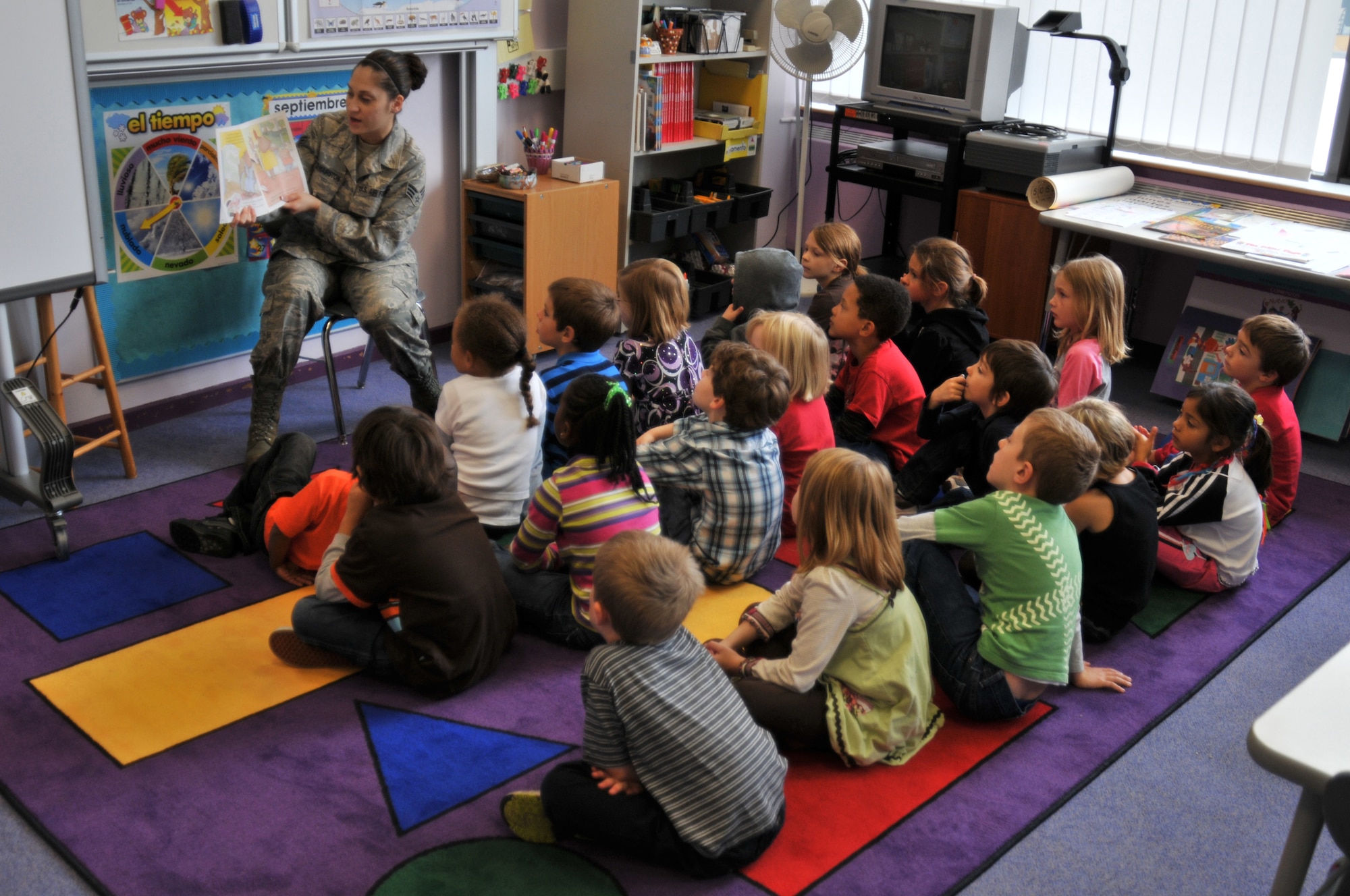 ROYAL AIR FORCE LAKENHEATH, England - Senior Airman Brendalee Lopez-Hairston, 48th Logistics Readiness Squadron Stock Control journeyman, reads ‘Abuelo and the Three Bears’ to a class of 1st-grade students at Lakenheath Elementary School, Sept. 28, 2010. Children will be going back to school Aug. 29, 2011. (U.S. Air Force photo/Senior Airman David Dobrydney)