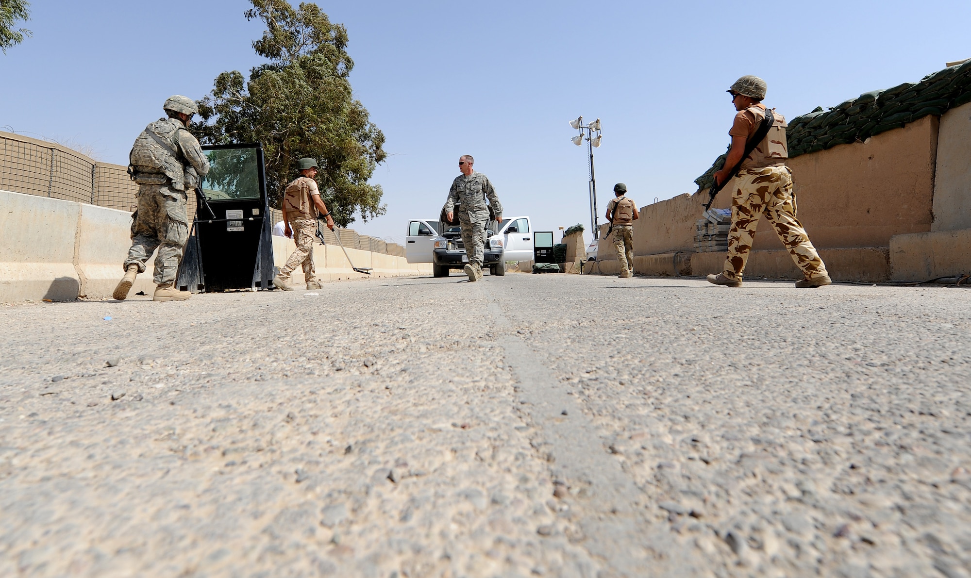 Iraqi Air Force members prepare to perform a vehicle search at Kirkuk Air Base. The Iraqis search the exterior and interior of the vehicles to look for bombs or anything that doesn't belong on base that could jeopardize the safety of any personnel. (U.S. Air Force photo by Senior Airman Tristin English)