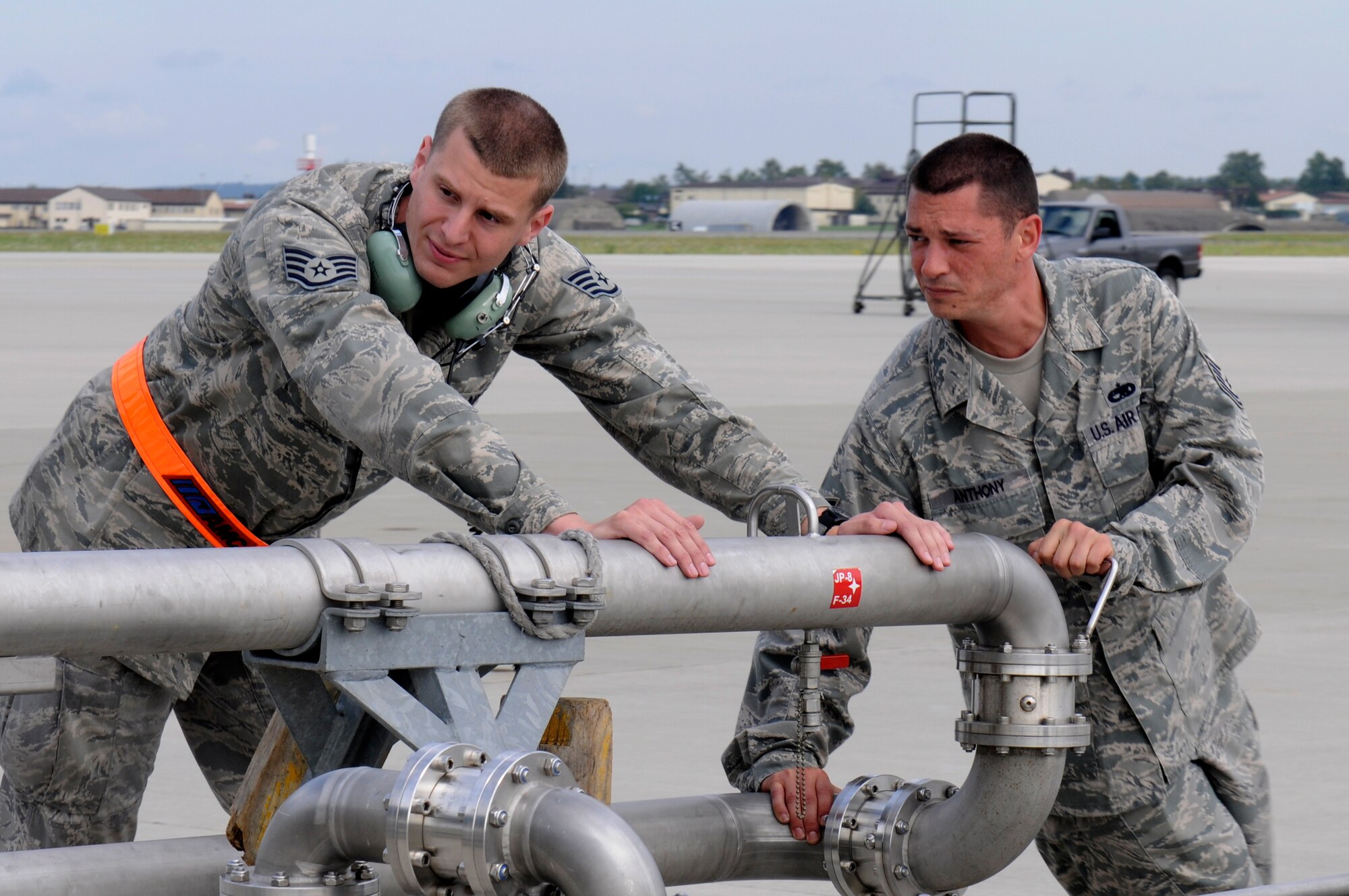SPANGDAHLEM AIR BASE, Germany -- Staff Sgt. Michael Irigoin, 726th Air Mobility Squadron avionics technician, left, and Tech Sgt. Raphael Anthony, 726th AMS crew chief, move refueling pantographs during a Logistics Compliance Assessment Program inspection here Aug. 24. The LCAP is held bi-annually to ensure all logistics and maintenance squadrons are able to perform key logistics processes in a compliant manner. (U.S. Air Force photo/Airman 1st Class Brittney Frees)
