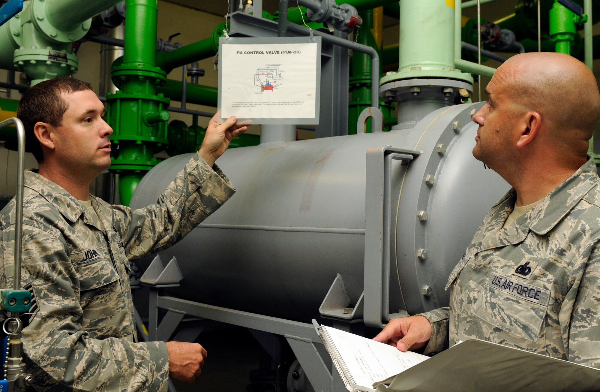 SPANGDAHLEM AIR BASE, Germany -- Tech Sgt. James Johnson, 52nd Logistics Readiness Squadron hydrants NCO in charge, left, shows Senior Master Sgt. Eric McGahey, Air Combat Command Logistics Compliance Assessment Program inspector, a training aid for a control valve here Aug. 24. The LCAP is held bi-annually to ensure all logistics and maintenance squadrons are able to perform key logistics processes in a compliant manner. (U.S. Air Force photo/Airman 1st Class Brittney Frees)