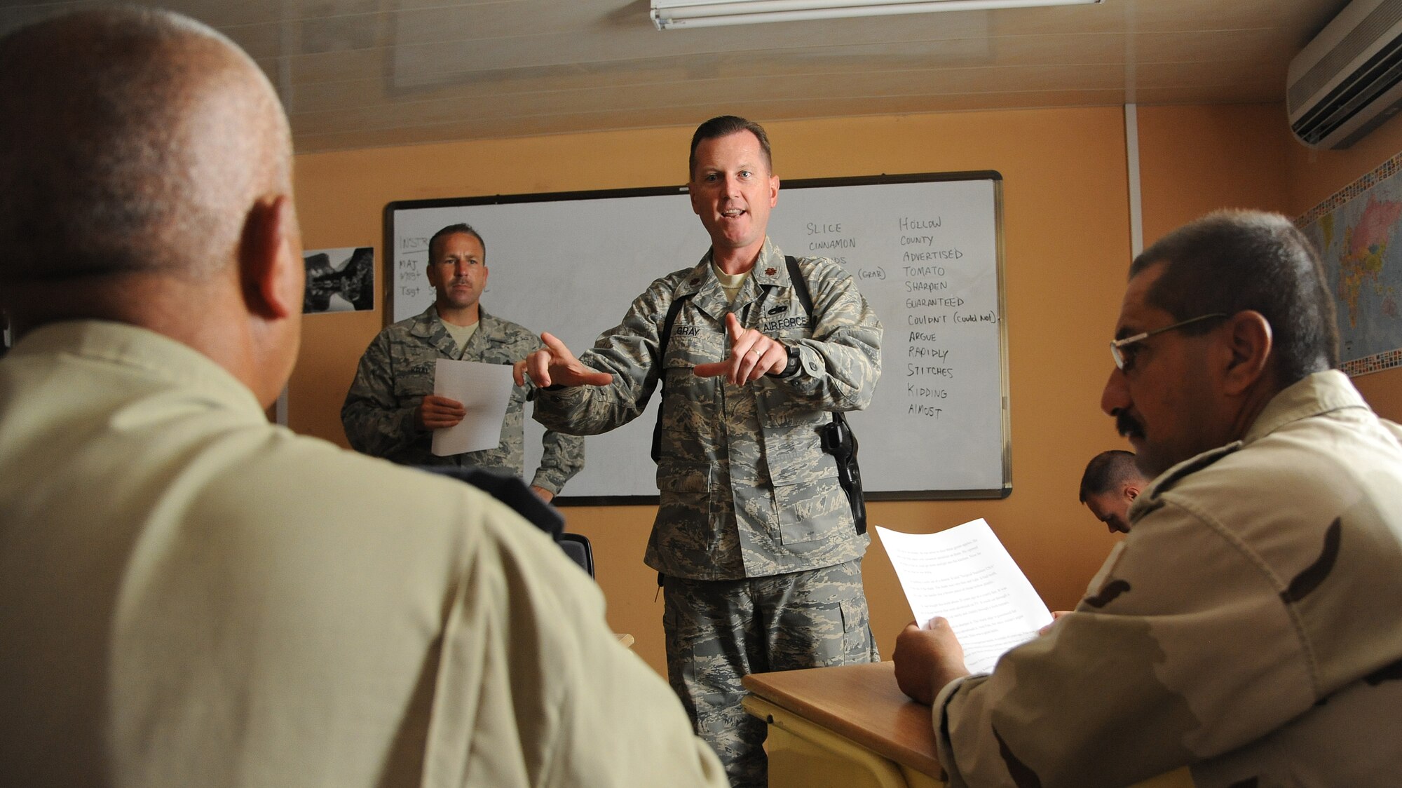 Maj. Mark Gray, 321st Air Expeditionary Advisory Group director of maintenance, helps teach the basics of the English language two hours a day, four days a week to the Iraqi maintainers at Kirkuk Air Base, Iraq.  Iraqi maintenance professionals have to learn the English language because all of their manuals are written in English, and only an estimated 15 out of 200 Iraqi Airmen have knowledge of the language. (U.S. Air Force photo by Senior Airman Tristin English)