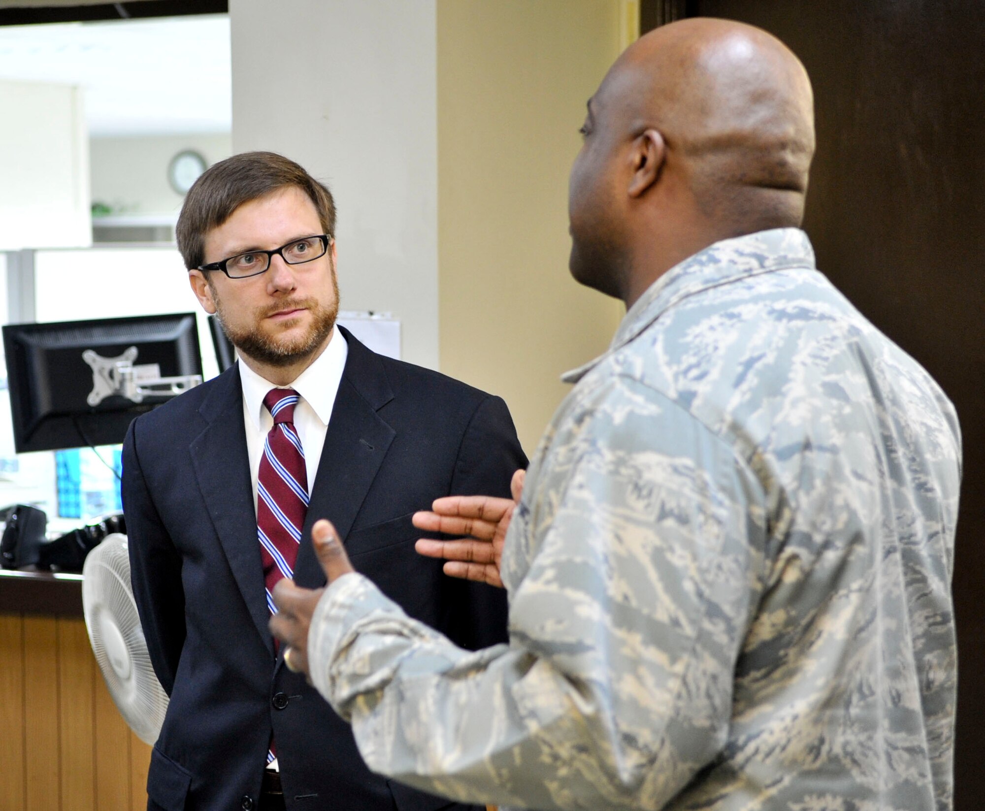 Assistant Secretary of the Air Force Jamie Morin listens Aug. 19, 2011, to Maj. Michael Tatum, 51st Comptroller Squadron commander, explain challenges faced by Osan Airmen. The assistant secretary toured the base Aug. 18-21 on an 11-day orientation trip to PACAF. (U.S. Air Force photo/Senior Airman Adam Grant)