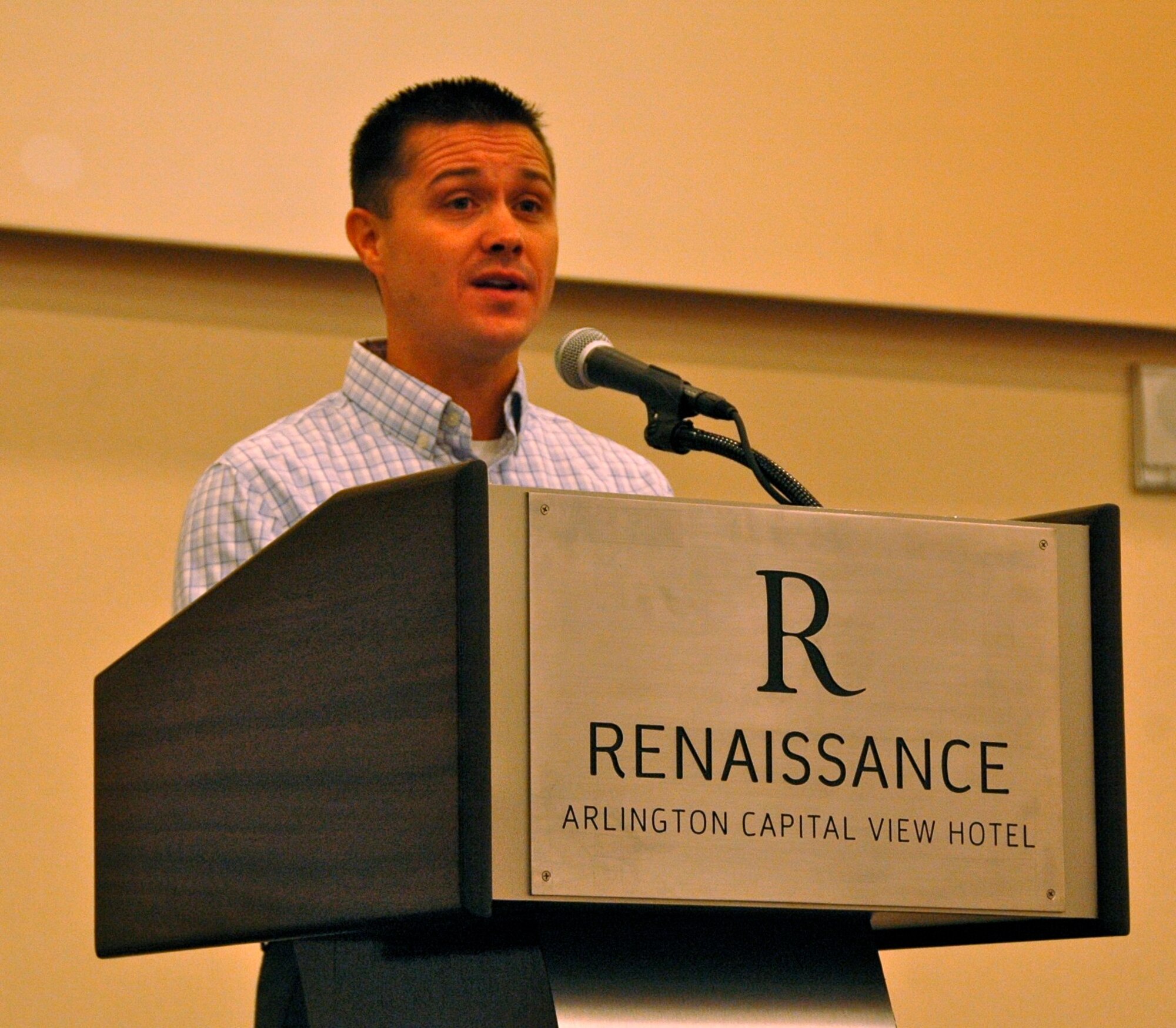 Maj. Todd J. Riddle, a Yellow Ribbon coordinator and pilot from the 442nd Fighter Wing, Whiteman Air Force Base, emcees the Yellow Ribbon event held in Arlington, Aug. 20, 2011.  Over 210 Airmen and their families attended the reintegration event.  (Air Force photo/Staff Sgt. Kimberly Hickey)  