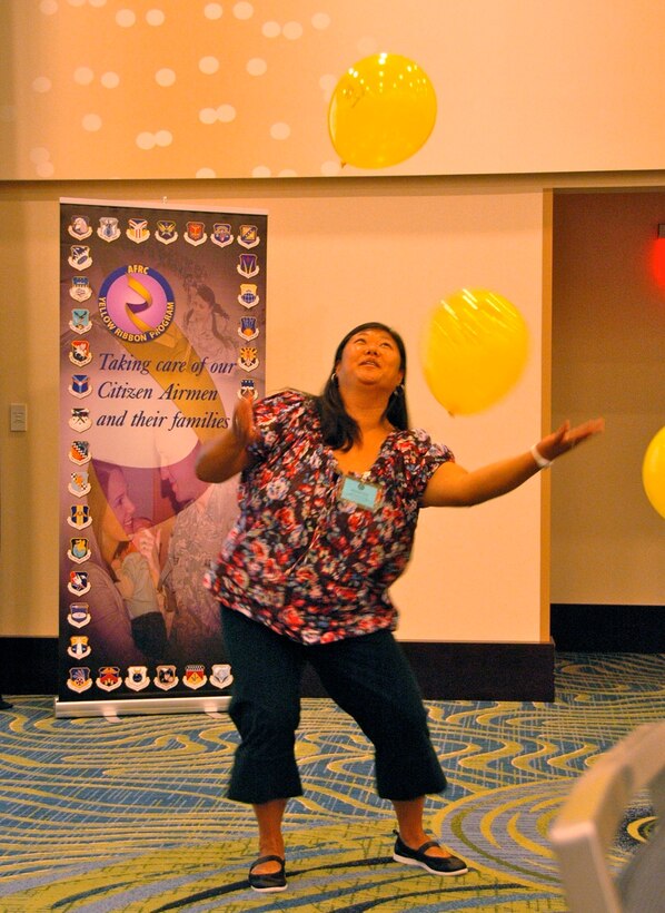 Amanda Finch, wife of SrA Kevin Finch, an aerial porter with 27 APS, volunteers for a demonstration on balancing multiple tasks during a Yellow Ribbon event in Arlington, VA, Aug. 20, 2011.  (Air Force photo/Staff Sgt. Kimberly Hickey) 
