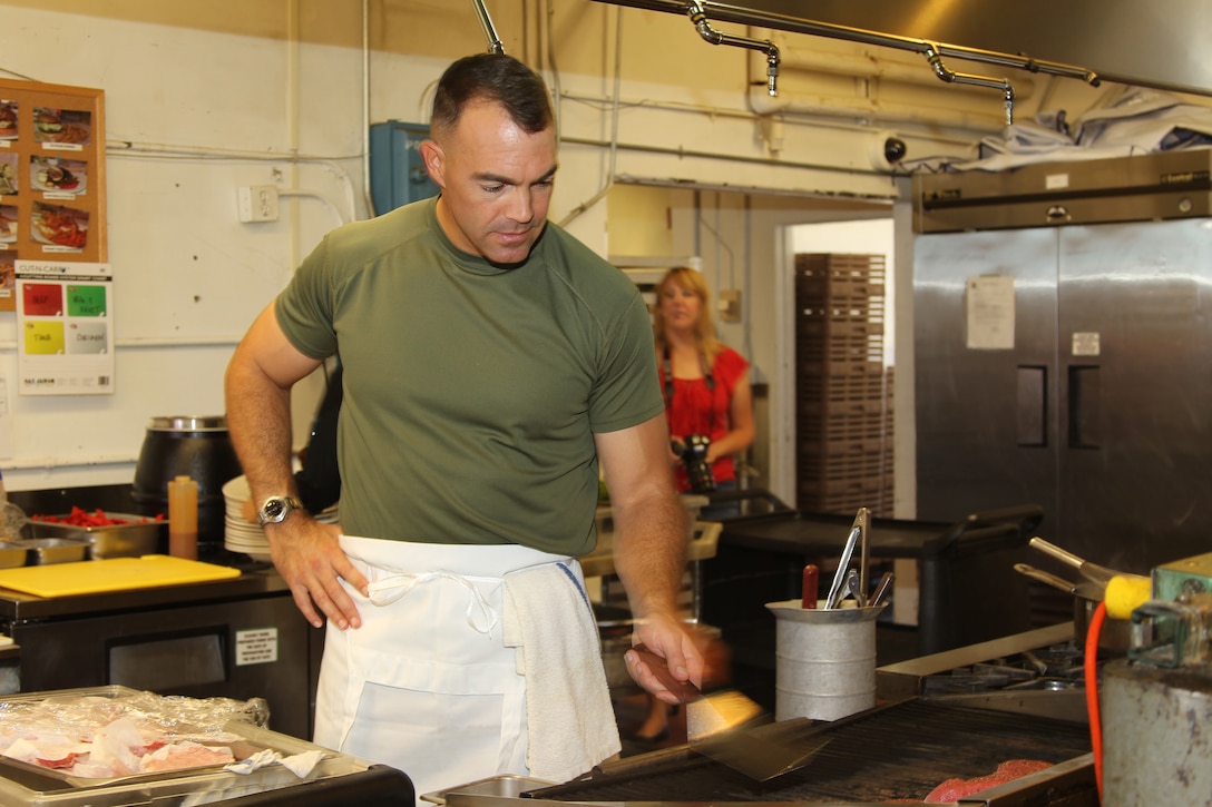 The Officers’ Club guest chef, Lt. Col. Phillip Zeman, battalion commander of Headquarters Battalion, Marine Corps Air Ground Combat Center, takes great care to ensure ahi tuna steaks are grilled to perfection while preparing the lunch special Aug. 26, 2011. Zeman cooked more than 40 orders of Tuna Barcelona, seared ahi tuna stuffed with feta cheese, sun-dried tomatoes and fresh basil, for O’Club diners.