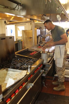 Lt. Col. Phillip Zeman, battalion commander of Headquarters Battalion, Marine Corps Air Ground Combat Center, begins grilling ahi tuna steaks in the Officer’s Club kitchen. Zeman, the guest chef during lunch service Aug. 26, 2011, said he got the recipe from a restaurant he used to frequent when stationed in Worcester, Mass.