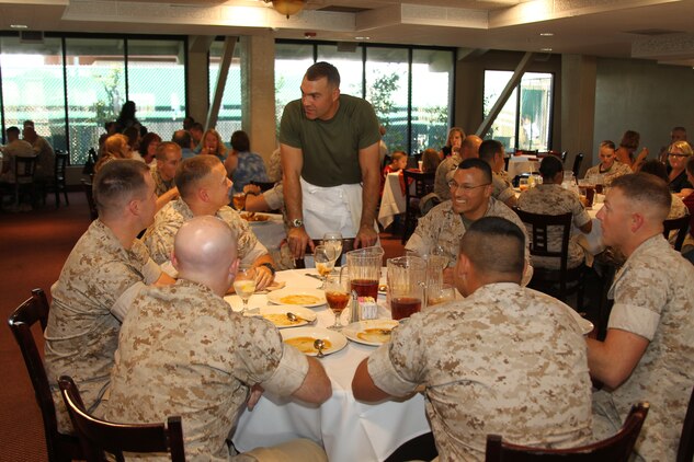 The Officer’s Club guest chef, Lt. Col. Phillip Zeman, battalion commander of Headquarters Battalion, Marine Corps Air Ground Combat Center, speaks with diners during a short break from cooking Aug. 26, 2011. Zeman prepared Tuna Barcelona – seared ahi tuna stuffed with feta cheese, sun-dried tomatoes and fresh basil.
