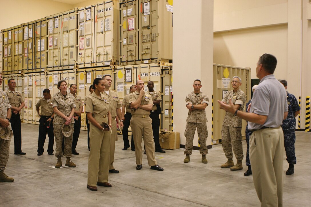 Bill Hartmann, the program manager for the expeditionary medical facility program, explains the purpose and function of EMFs to Marines and sailors on Camp Foster Aug. 26. EMFs are modular facilities created to provide shore-based medical support to the fleet and Fleet Marine Forces.
