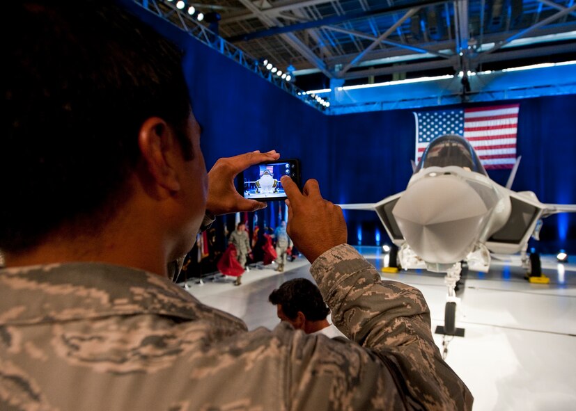 An Airman snaps a picture with his phone of the F-35 Lightning II joint strike fighter after its official rollout ceremony Aug. 26 at Eglin Air Force Base, Fla.  (U.S. Air Force photo/Samuel King Jr.)