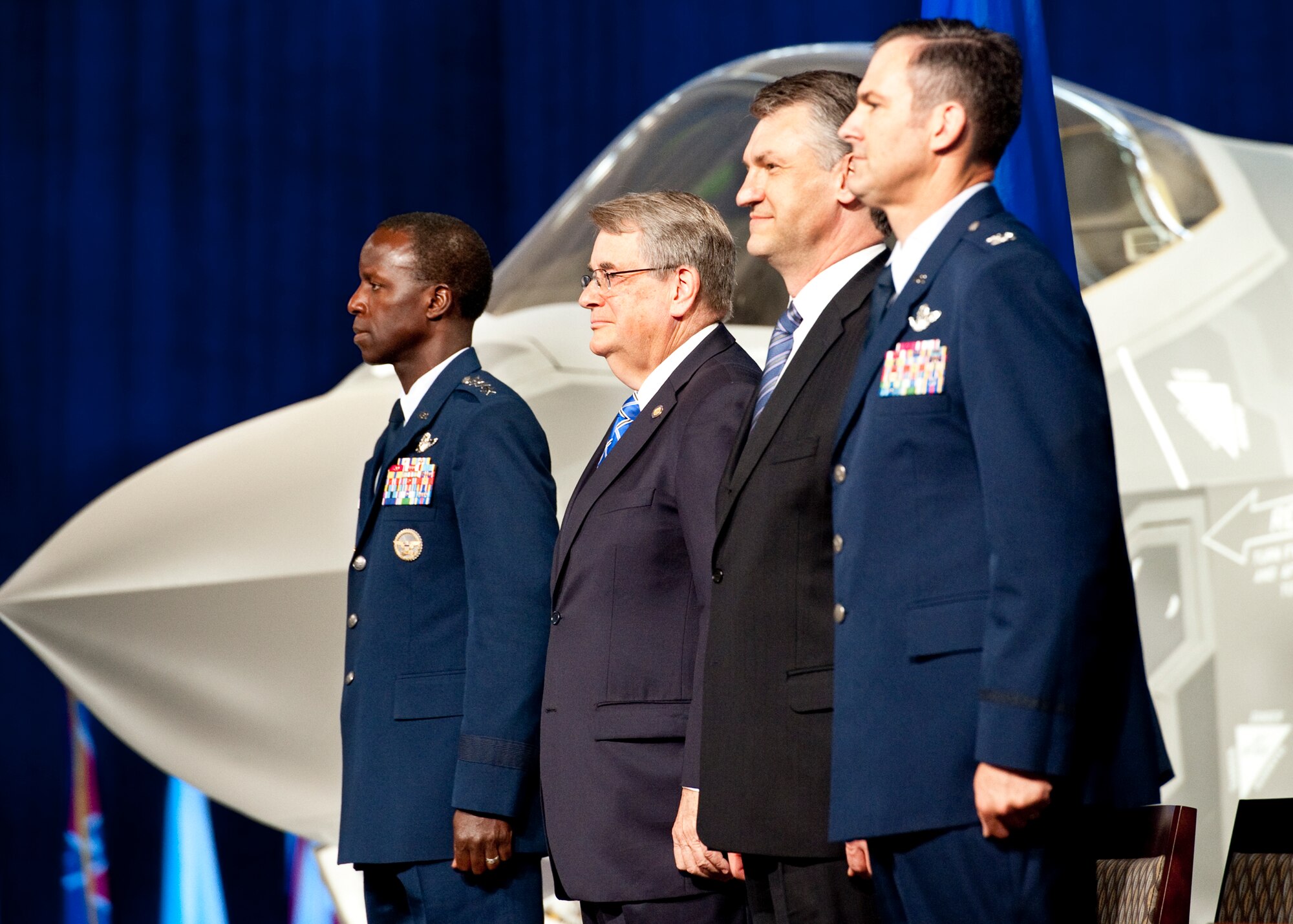 Gen. Edward Rice, the Air Education and Training Command commander, stands with Florida Sen. Don Gaetz, Larry Lawson, the executive vice president and general manager of the F-35 program for Lockheed Martin, and Col. Andrew Toth, the 33rd Fighter Wing commander at the conclusion of the F-35 Lightning II joint strike fighter rollout ceremony Aug. 26 at Eglin Air Force Base, Fla.  (U.S. Air Force photo/Samuel King Jr.)