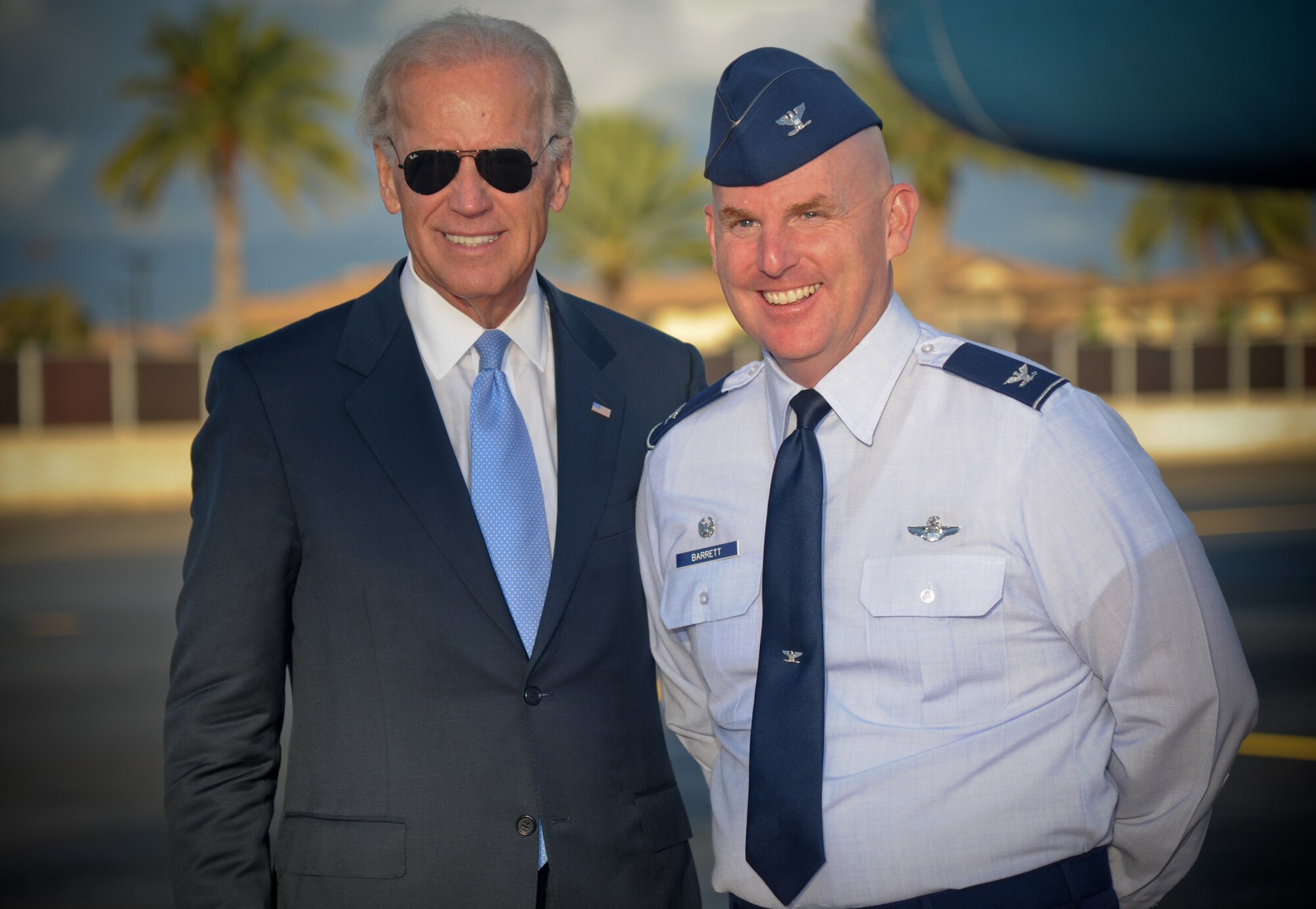 Vice President Biden stops to pose for a photo with Col. Sam Barrett, 15th Wing commander, as he prepares to depart Joint Base Pearl Harbor-Hickam, Hawaii, Aug. 25. Biden made a brief stop on the island after returning from a visit overseas. (U.S. Air Force photo/ Senior Airman Lauren Main)