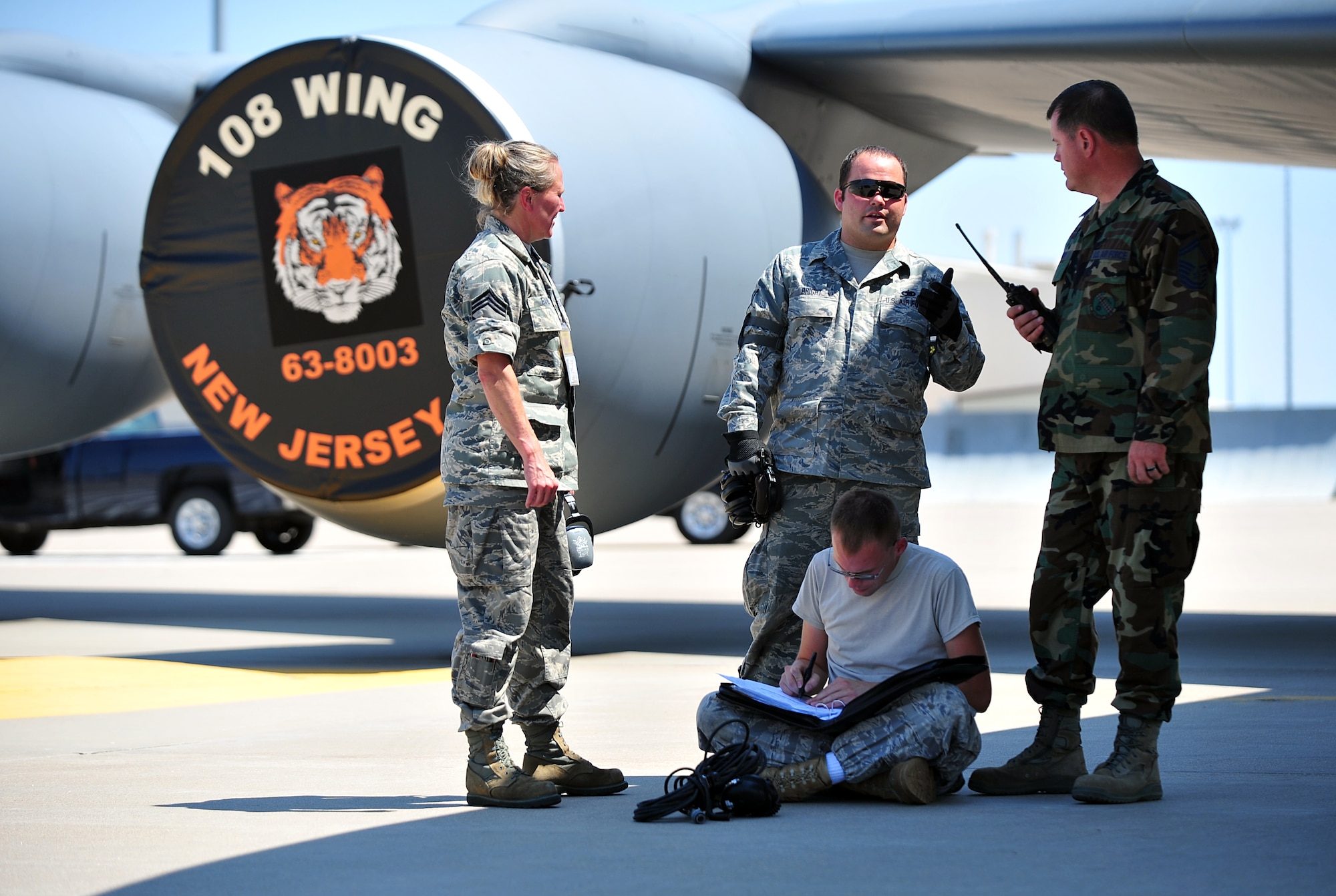 Chief Master Sgt. Michelle Evan, 108th Aircraft Maintenance Squadron flight chief, left, Staff Sgt. Jared Bright, 108th AMXS crew chief, and Senior Master Sgt. Martin Currey 931st AMXS production superintendent, discuss bed down plans for five Air National Guard 108th Wing KC-135 Stratotanker aircraft which evacuated to McConnell AFB, Kan., Aug. 26, 2011.  Team McConnell helped secure the aircraft so the McGuire Airmen could return to their homestation to prepare for Hurricane Irene’s approach.  (U.S. Air Force photo by Senior Airman Courtney Witt)