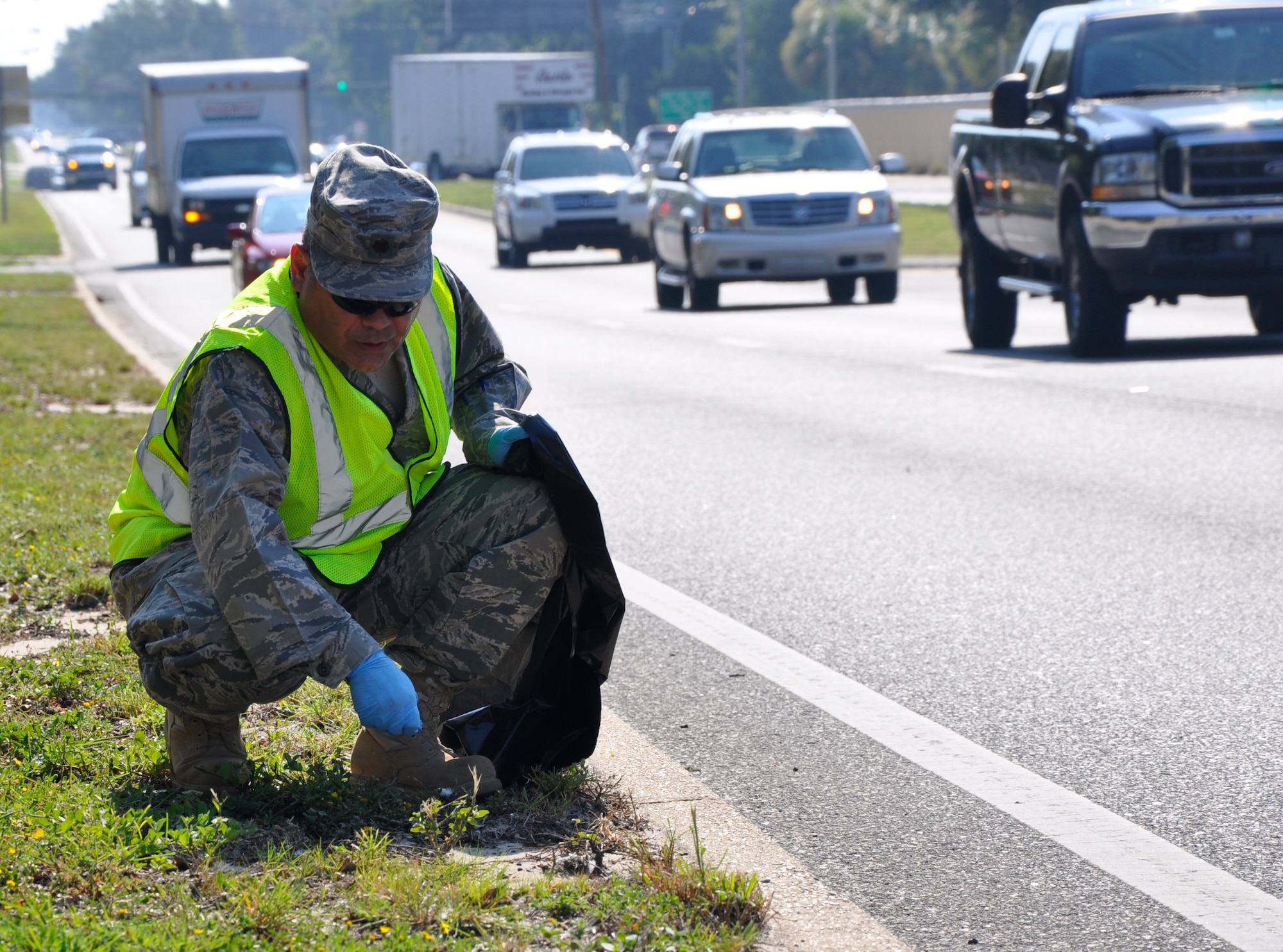 Maj. Paul Castillo, 1st Special Operations Wing chaplain, picks up trash as part of a volunteer clean up effort outside of Hurlburt Field, Fla., Aug. 26, 2011. The effort to beautify the two-mile area along Highway 98 was sponsored by the Air Force Sergeants Association Chapter 567 committee. (U.S. Air Force photo by Senior Airman Joe McFadden)