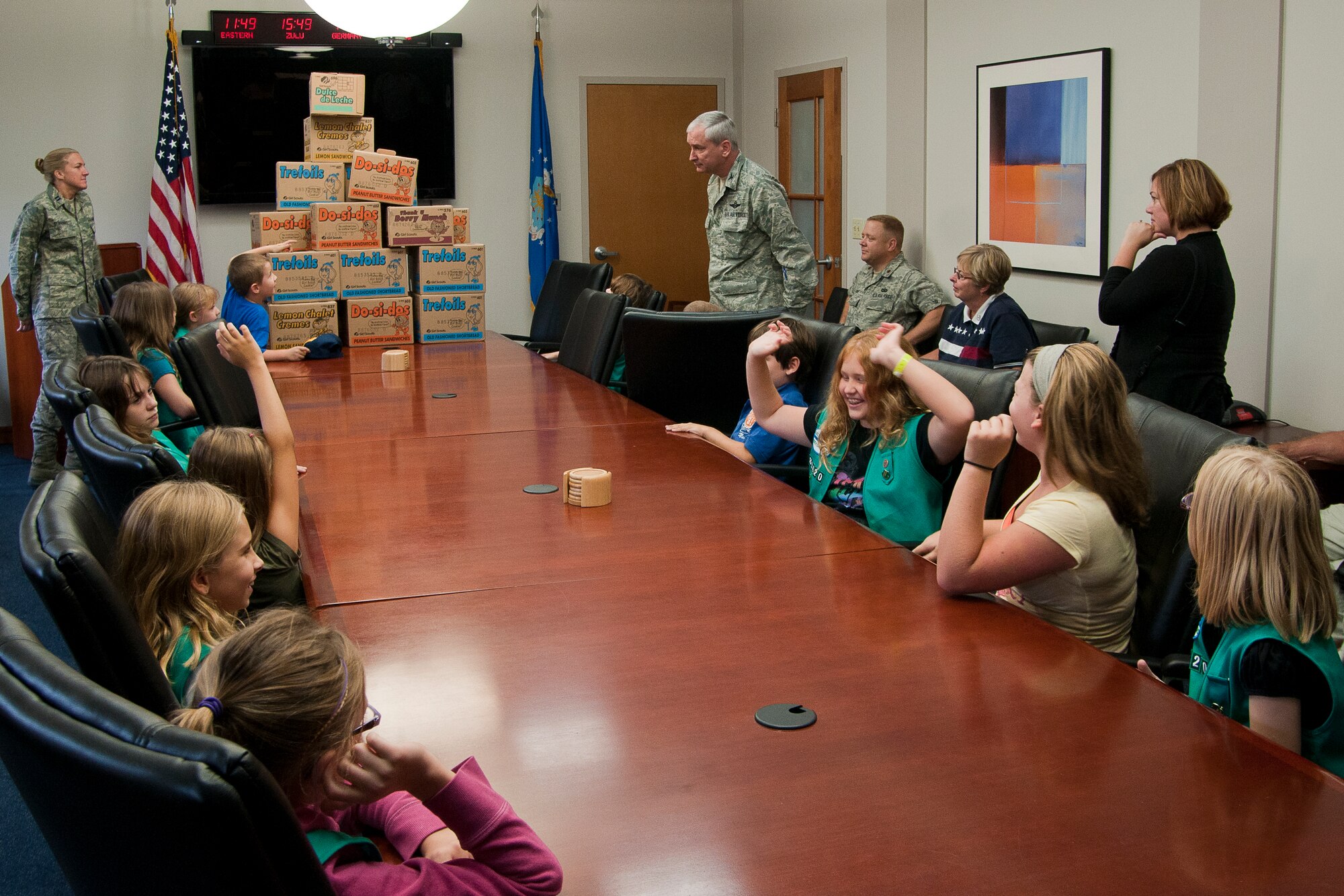 Youngstown Air Reserve Station, Ohio--Col. Fritz Linsenmeyer (standing, back center), 910th Airlift Wing commander, addresses Girl Scout troop 80420 of Canfield, Ohio, here, August 26th. The troop was at Youngstown Air Reserve Station for a base tour which included a walkthrough of our fire department and a C-130 Hercules aircraft. The troops donated several large boxes of Girl Scout cookies to the troops. The cookies will be distributed to deploying unit members. Photo by Mr. Eric M. White 