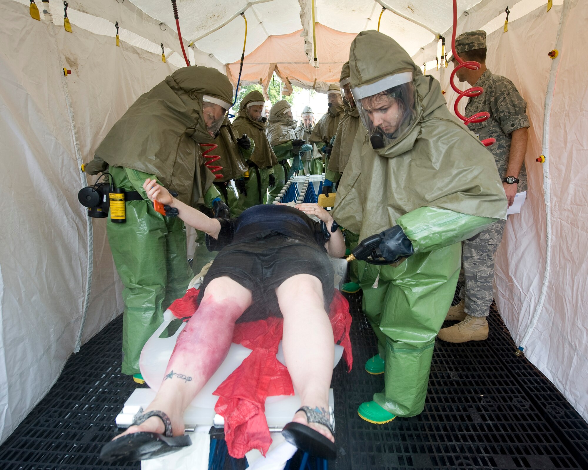 Members of the 2nd Medical Group decontaminate a simulated victim as part of a major accident response exercise on Barksdale Air Force Base, La., Aug. 25. The MARE was used to provide feedback to wing leadership about emergency management capabilities. (U.S. Air Force photo/Senior Airman Chad Warren) (RELEASED)