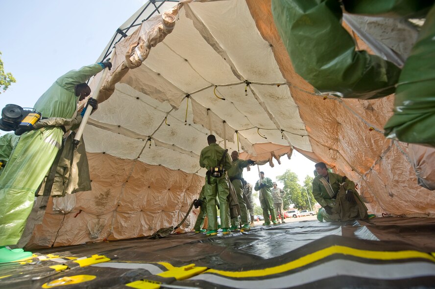 Personnel of the 2nd Medical Group set up a tent in the parking lot of the clinic on Barksdale Air Force Base, La., Aug. 25. The tent was constructed to decontaminate simulated victims as part of a major accident response exercise. (U.S. Air Force photo/Senior Airman Chad Warren) (RELEASED)