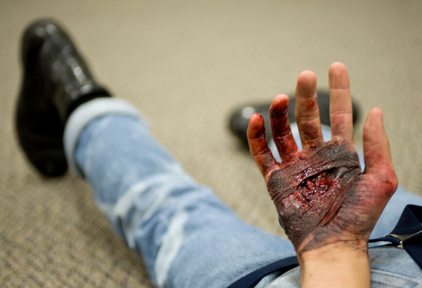 A simulated victim lays on the ground during a scenario at Hoban Hall on Barksdale Air Force Base, La., Aug. 25. The simulation was part of a major accident response exercise and used volunteers to act as victims during an attack. (U.S. Air Force photo/Senior Airman Chad Warren) (RELEASED)
