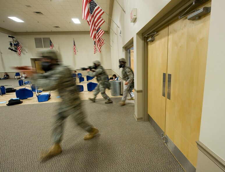 Personnel of the 2nd Security Forces Squadron arrive on scene following a simulated attack at Hoban Hall on Barksdale Air Force Base, La., Aug. 25. The simulation was part of a major accident response exercise. (U.S. Air Force photo/Senior Airman Chad Warren) (RELEASED)