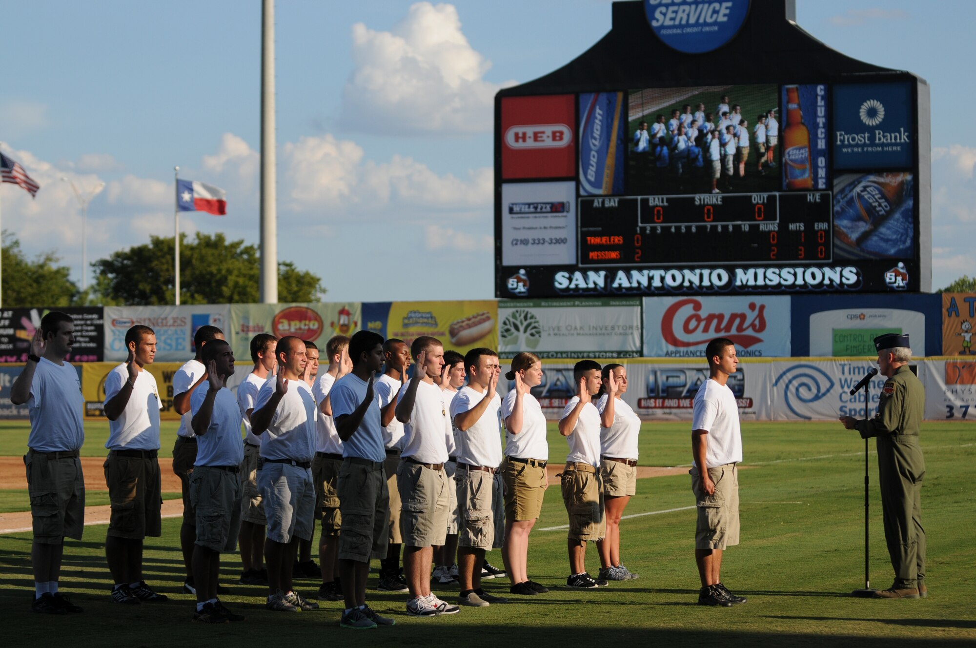 Colonel (Col) John Kane, commander of the 149th Fighter Wing, swears in new recruits into the unit during Texas Air National Guard night with the San Antonio Missions AA baseball club, August 21, 2011.  (Air National Guard photo by SSgt Eric L. Wilson/Released)