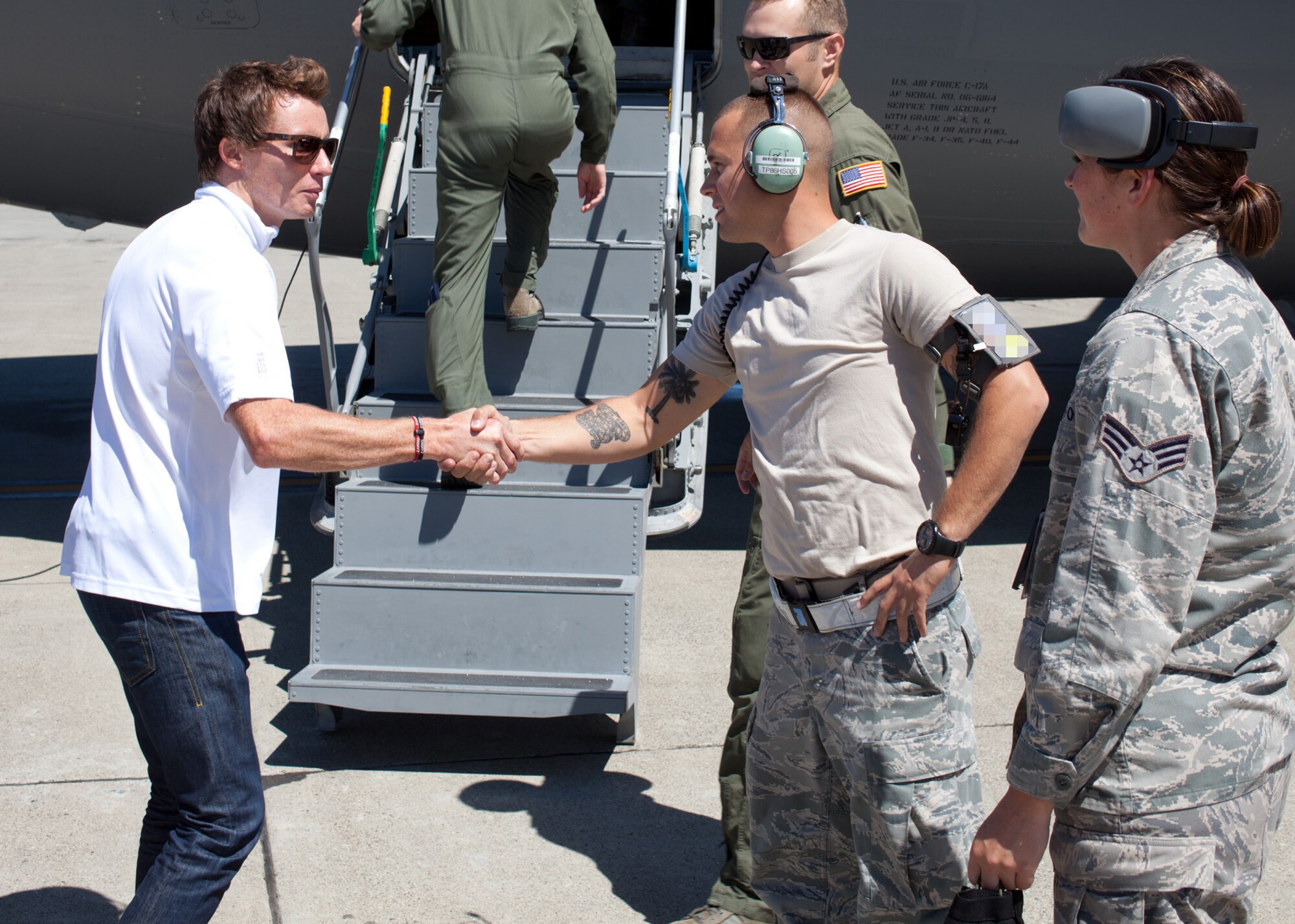 TRAVIS AIR FORCE BASE, Calif. --Mike Conway, driver of the #27 car for the Andretti Autosport IndyCar Team, shakes hands with Airman 1st Class Corey Blackman, a crew chief with the 860th Aircraft Maintenance Squadron prior to a C-17 Globemaster III orientation flight at Travis AFB, Calif., Aug 25, 2011.  Orientation flights for civic leaders, professional athletes and journalists help the American public better understand the contributions of the military to our national defense.  Members of the Andretti Autosport Team observed this routine, local training flight with an Air Force Reserve crew prior to participation at the nearby Grand Prix of Sonoma.  (U.S. Air Force photo / Lt. Col. Robert Couse-Baker)