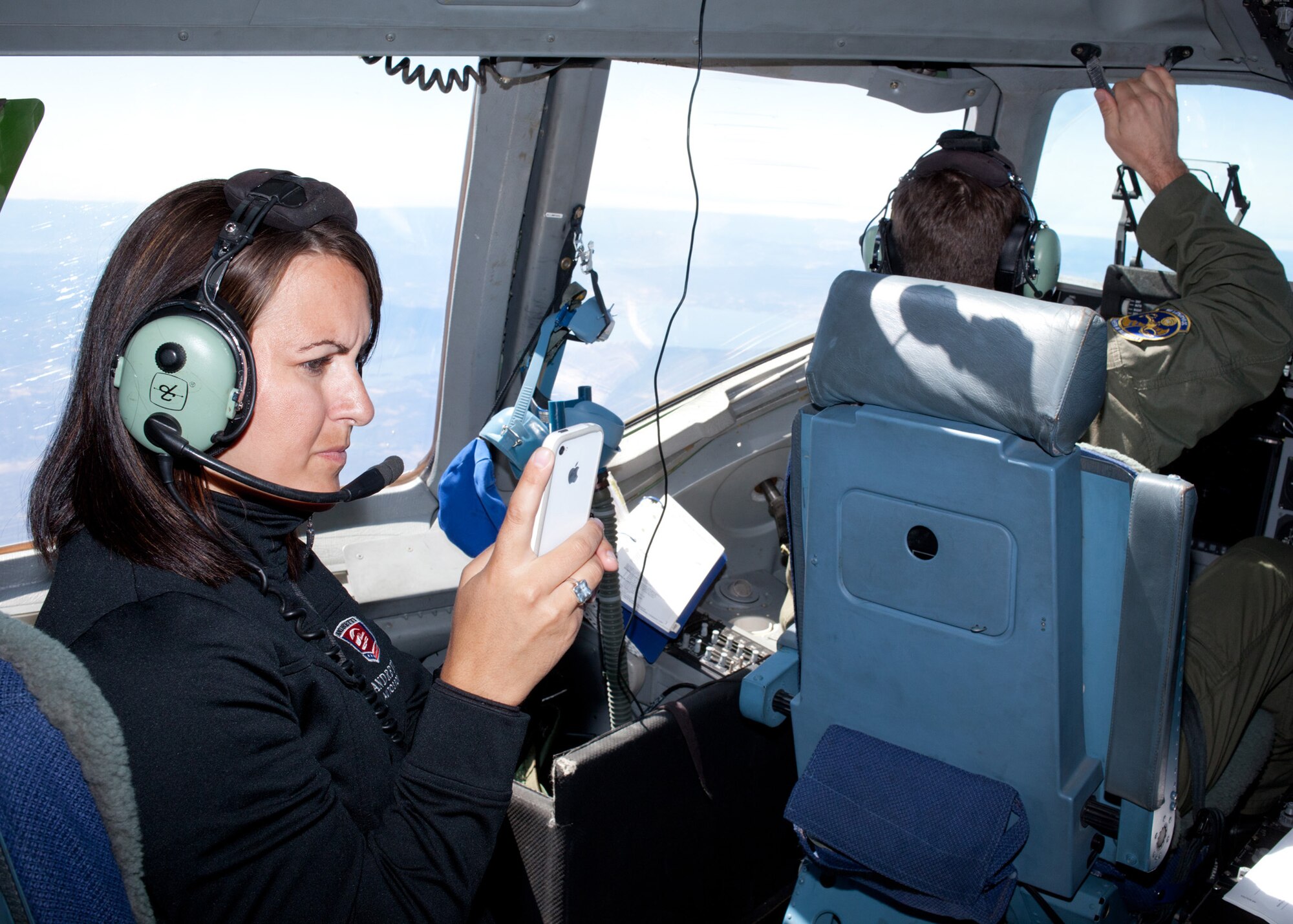 TRAVIS AIR FORCE BASE, Calif. -- Ryann Rigsby, director of the Michael Andretti Foundation takes a photo a photo on the flight deck of C-17 Globemaster III "Spirit of Vallejo" during an orientation flight from Travis AFB, Calif., Aug 25, 2011.  Orientation flights for civic leaders, professional athletes and journalists help the American public better understand the contributions of the military to our national defense.  Members of the Andretti Autosport Team observed this routine, local training flight with an Air Force Reserve crew prior to participation at the nearby Grand Prix of Sonoma.  (U.S. Air Force photo / Lt. Col. Robert Couse-Baker)