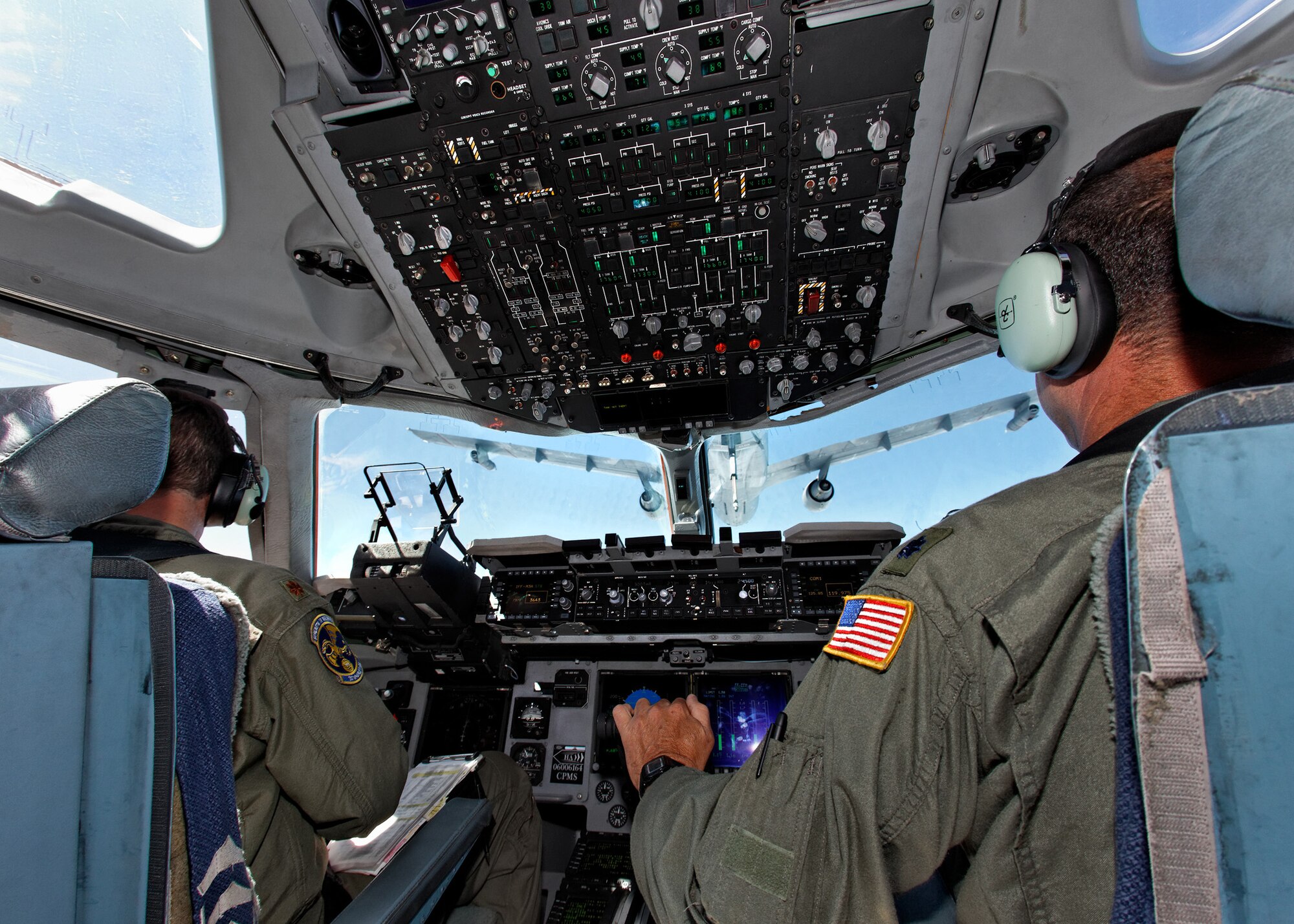 TRAVIS AIR FORCE BASE, Calif. -- Maj. Troy Ogle, a pilot with the 301st Airlift Squadron (left), and Lt. Col. Adam Willis, deputy commander of the 349th Operations Group, position a C-17 Globemaster III to receive fuel from KC-10A Extender over Northern California, Aug 25, 2011.  Aerial refueling extends the range U.S. and NATO aircraft, permitting rapid deployment of hope and might around the globe. Both aircraft and their Reserve crews are stationed at Travis AFB, Calif. (U.S. Air Force photo / Lt. Col. Robert Couse-Baker)