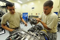 U.S. Air Force Airman 1st Class Alan Webb, 23rd Component Maintenance Squadron, and Staff Sgt. Joshua McKinney, 723rd Aircraft Maintenance Squadron, disassemble an HH-60 Pave Hawk engine during a Turbo Shaft Propulsion Course held at the 372nd Training Squadron on Aug. 23, 2011. The course is one of many which the 372nd Training Squadron holds to educate maintainers stationed at Moody Air Force Base, Ga. (U.S. Air Force photo by Staff Sgt. Joshua J. Garcia/Released)