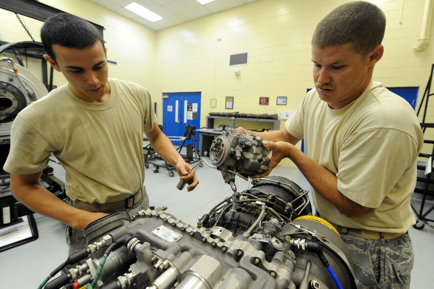 U.S. Air Force Airman 1st Class Alan Webb, 23rd Component Maintenance Squadron, and Staff Sgt. Joshua McKinney, 723rd Aircraft Maintenance Squadron, disassemble an HH-60 Pave Hawk engine during a Turbo Shaft Propulsion Course held at the 372nd Training Squadron on Aug. 23, 2011. The course is one of many which the 372nd Training Squadron holds to educate maintainers stationed at Moody Air Force Base, Ga. (U.S. Air Force photo by Staff Sgt. Joshua J. Garcia/Released)