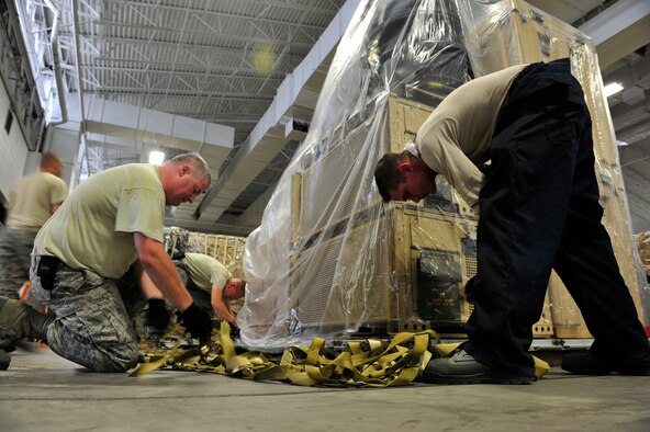 Airmen from the 621st Contingency Response Wing prepare emergency equipment for immediate response to Hurricane Irene at Joint Base McGuire-Dix-Lakehurst, N.J., Aug. 25, 2011. The roughly 600 Airmen of the wing specialize in creating aerial port and command-and-control facilities in damaged or hostile environments. Previous missions have included humanitarian responses to Haiti, Pakistan and Japan in the aftermath of earthquakes, floods and tsunamis in addition to Hurricanes Ike, Rita, Gustav and Katrina. (U.S. Air Force photo/Tech. Sgt. Parker Gyokeres)
