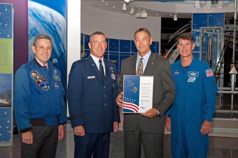 KENNEDY SPACE CENTER, Fla. -- From left, Bob Cabana, Director, Kennedy Space Center, Brig. Gen Ed Wilson, Commander, 45th Space Wing, Mike Gawel, 45 SW Space Shuttle Program Support Manager, 1st Range Operations Squadron, and NASA Astronaut Army Col. Shane Kimbrough, STS-126 mission specialist, congratulate Mr. Gawel for receiving the NASA Space Flight Awareness Silver Snoopy Award, during a ceremony Aug. 2 at KSC. Mr. Gawel received the once-in-a-lifetime astronauts’ personal award for his significant contributions to ensuring flight safety and mission success of the human space flight program. (NASA photo/Tony Gray)