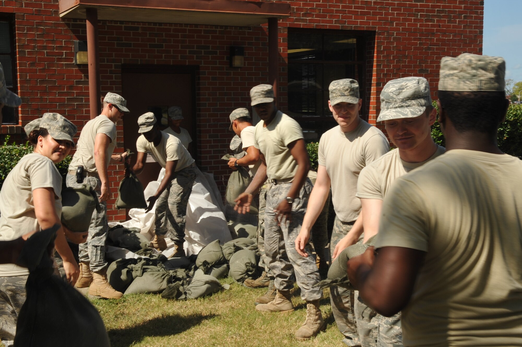 Airmen from the 633rd Communications Squadron sandbag the doorways at the base telephone office Aug. 25, 2011, in an effort to prevent flooding at Langley Air Force Base, Va.  The base is preparing for Hurricane Irene, which is expected to make landfall in the area early Sunday morning. (U.S. Air Force photo/Staff Sgt. Logan Tuttle)