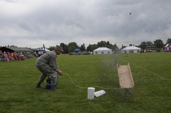 Col. Christopher Coffelt, 90th Missile Wing commander, launches his two-liter command rocket during the buffalo chip toss. This kicked off Frontiercade 2011. (U.S. Air Force photo by Blaze Lipowski)